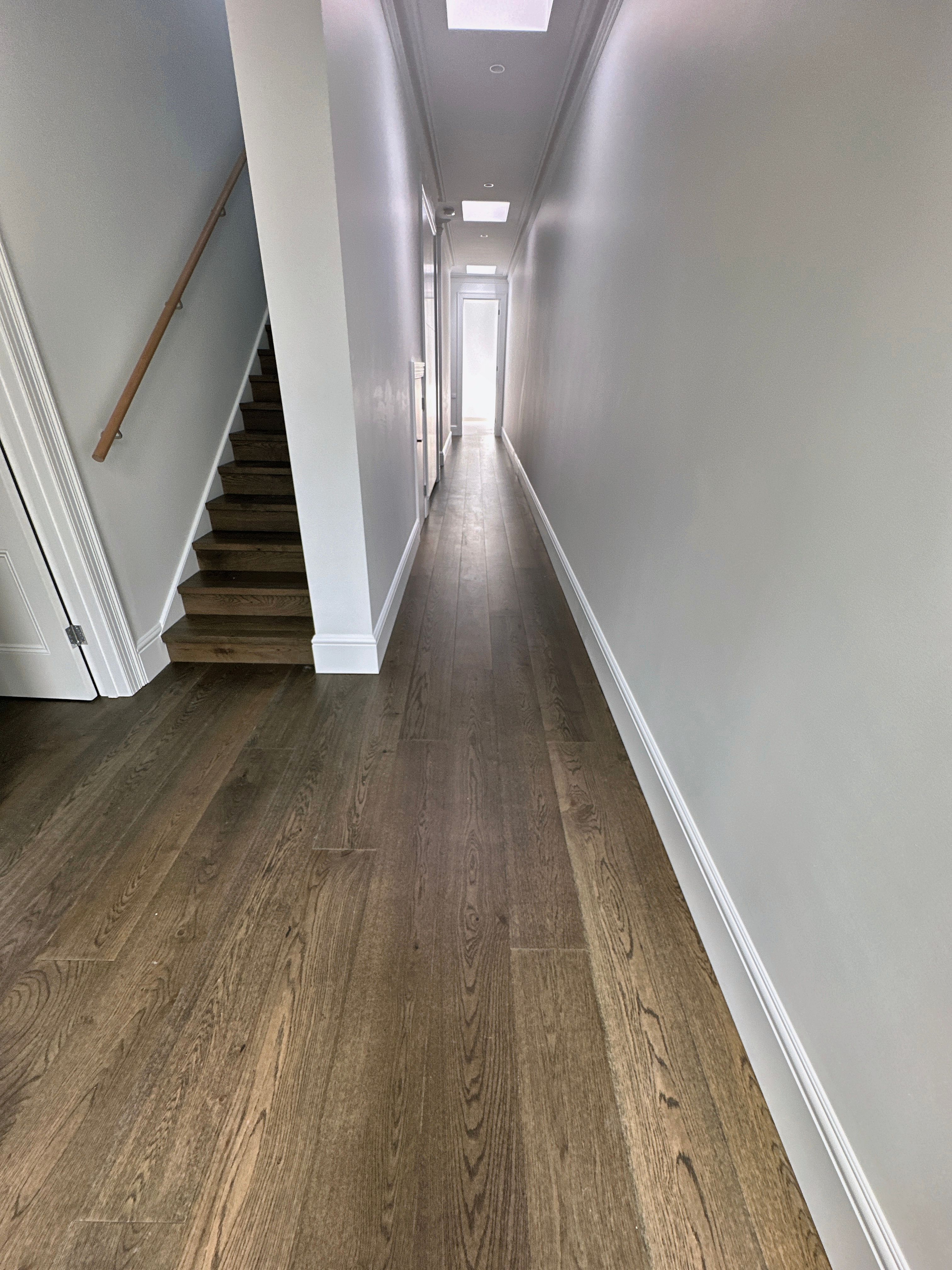 Straight-plank French Grey engineered oak flooring through a Toorak hallway.