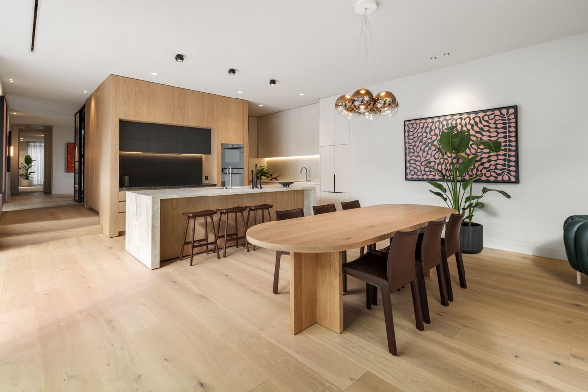 Open-plan Kew kitchen and dining room with Avoca Bay engineered oak flooring.