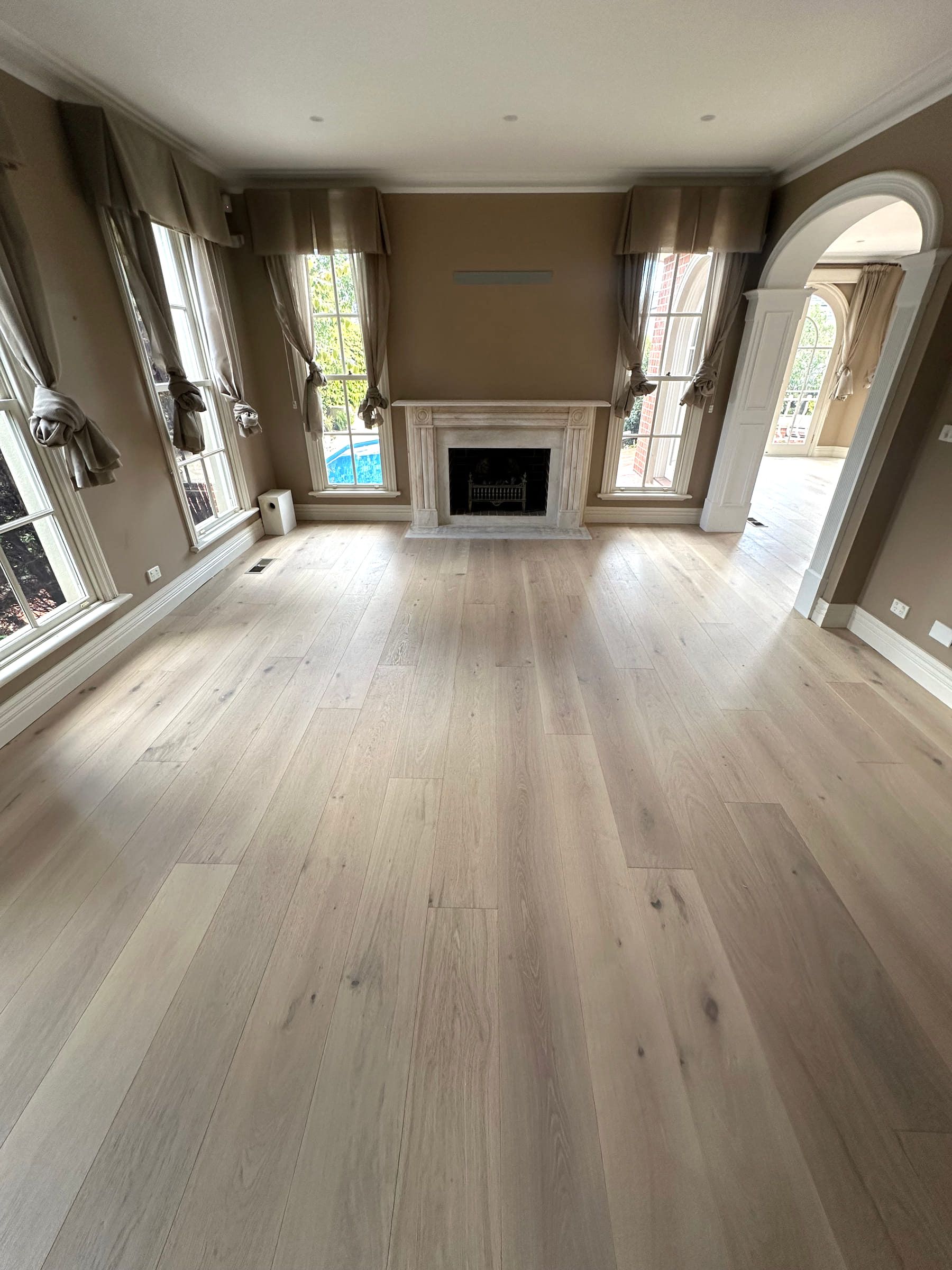 Tealight oak flooring in a Camberwell living room with a central fireplace.