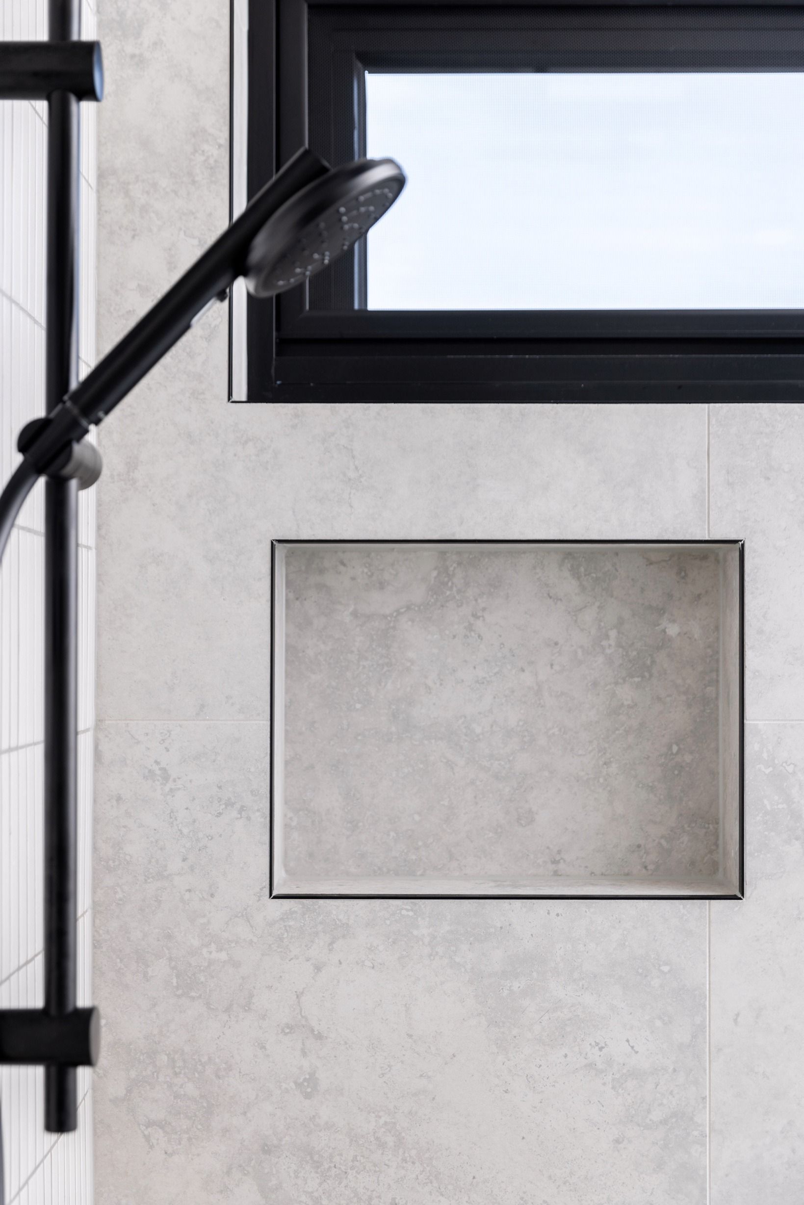 Black shower frame and recessed shelf in the Glen Iris bathroom.