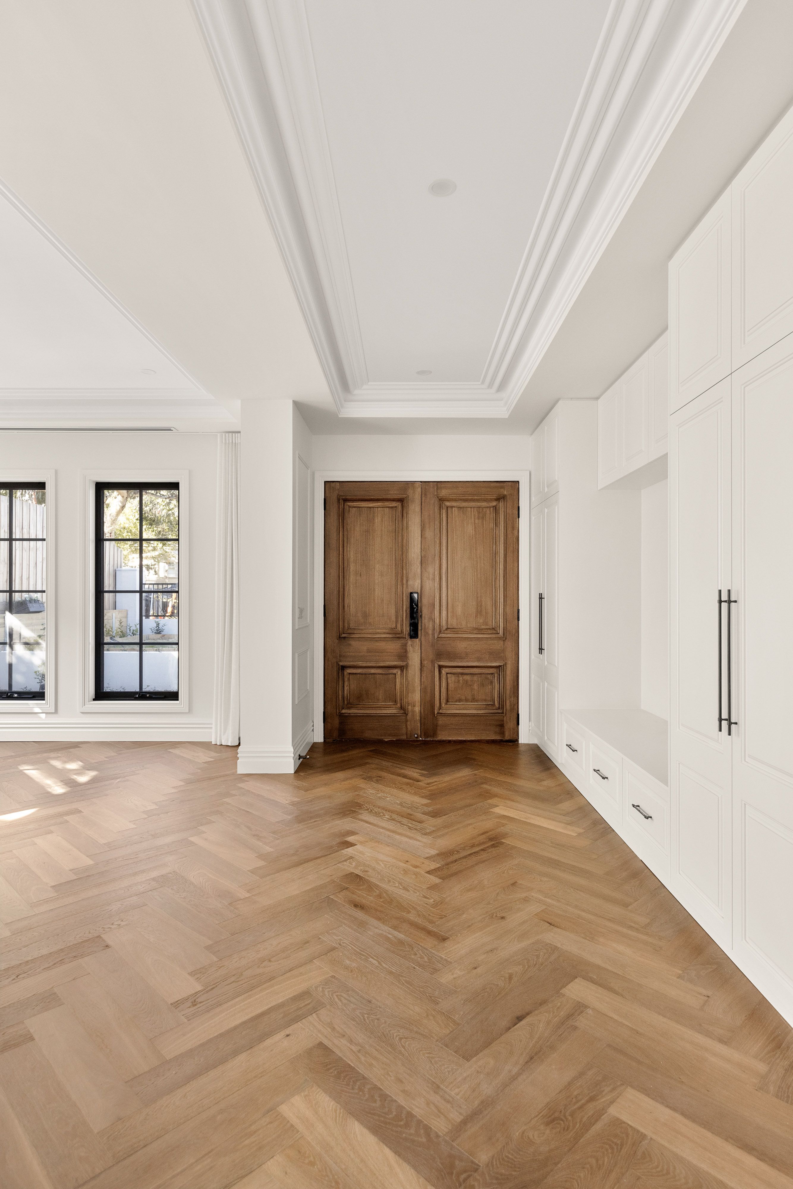 Smoked Brown herringbone flooring aligned through a Balwyn entrance hall.