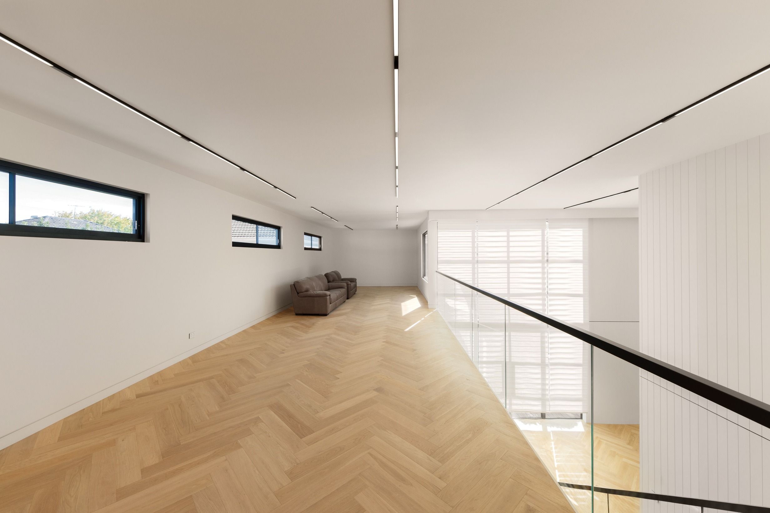 Natural Oak herringbone flooring across an upper-level Kew landing.