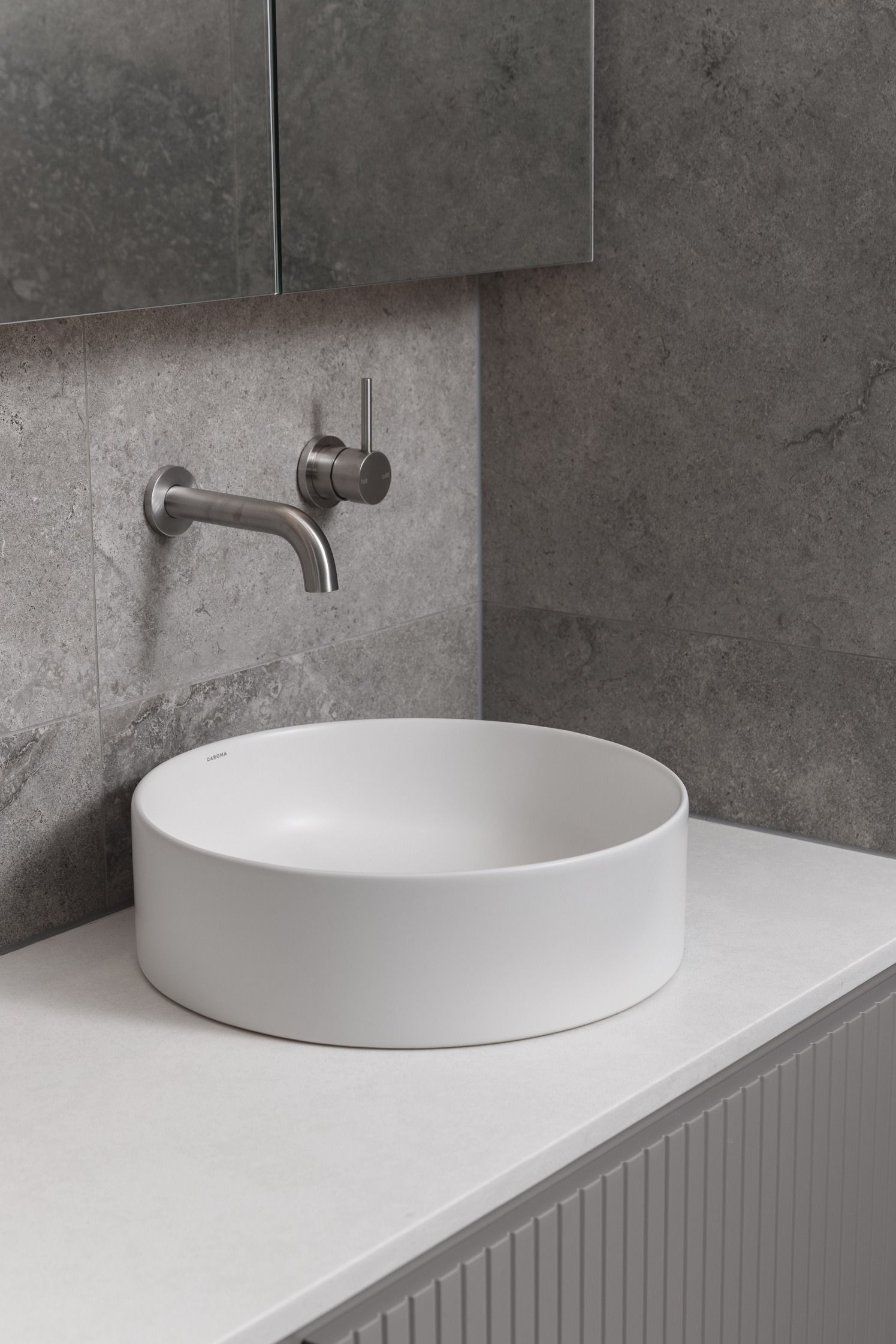 Stone powder room vanity in the completed Kew residence.