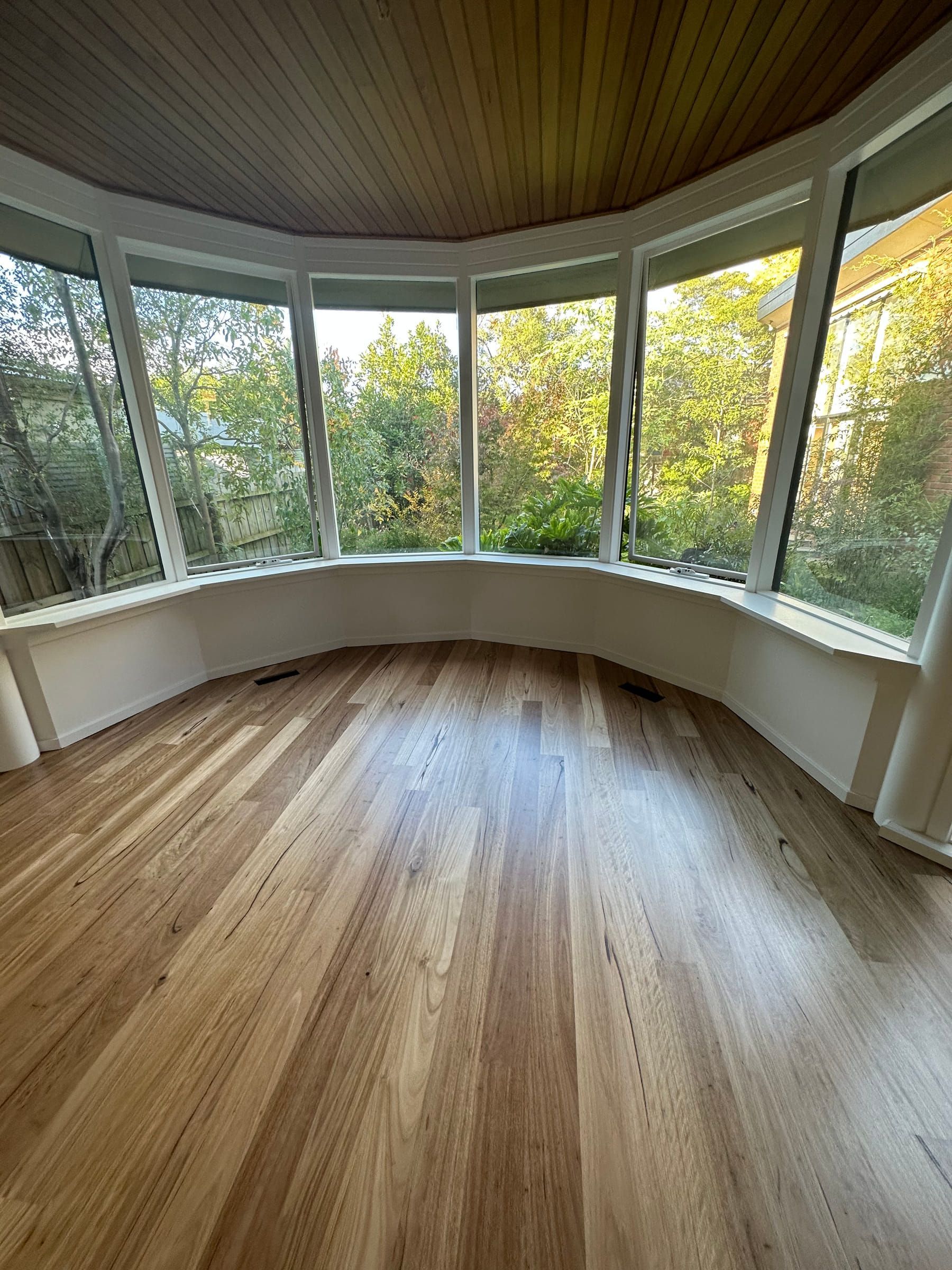 Standard-grade Blackbutt flooring in a curved bay-window room in Malvern.