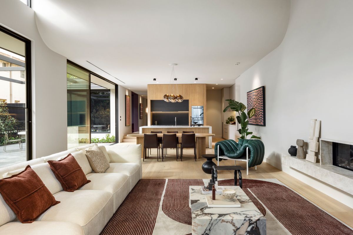 Avoca Bay oak flooring linking the living room and kitchen of a Kew home.