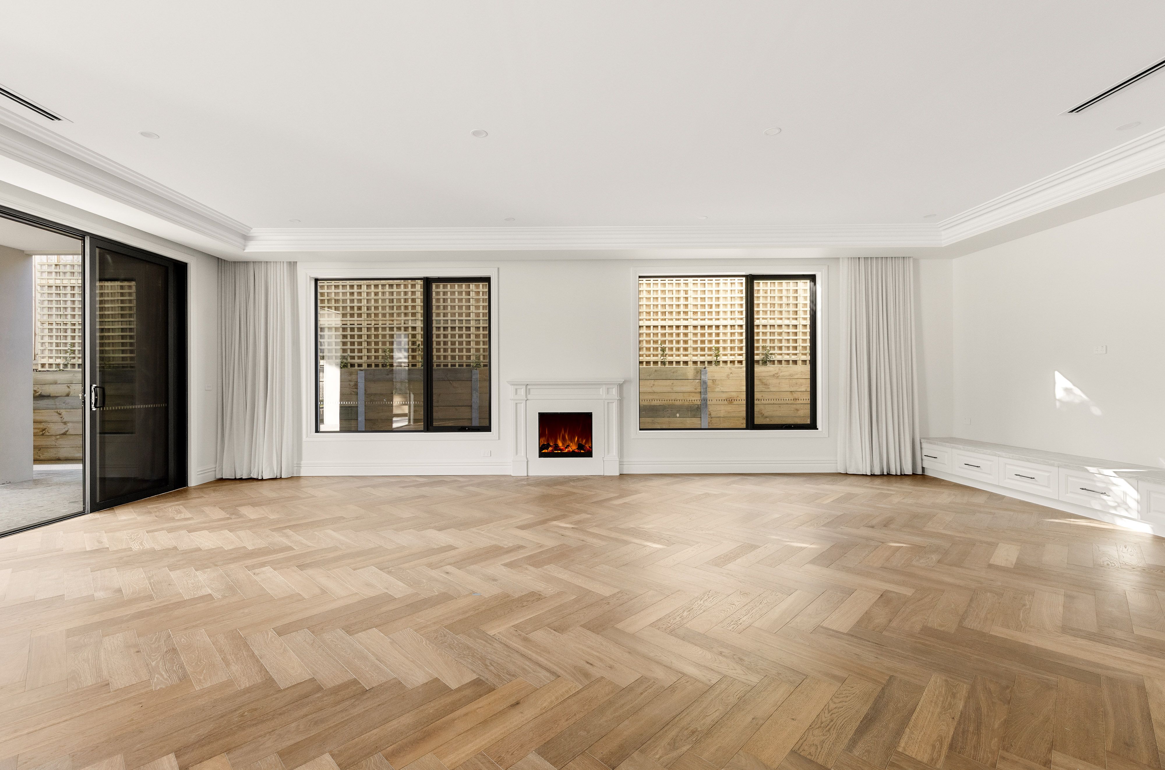 Smoked Brown herringbone flooring through a Balwyn living room with fireplace.