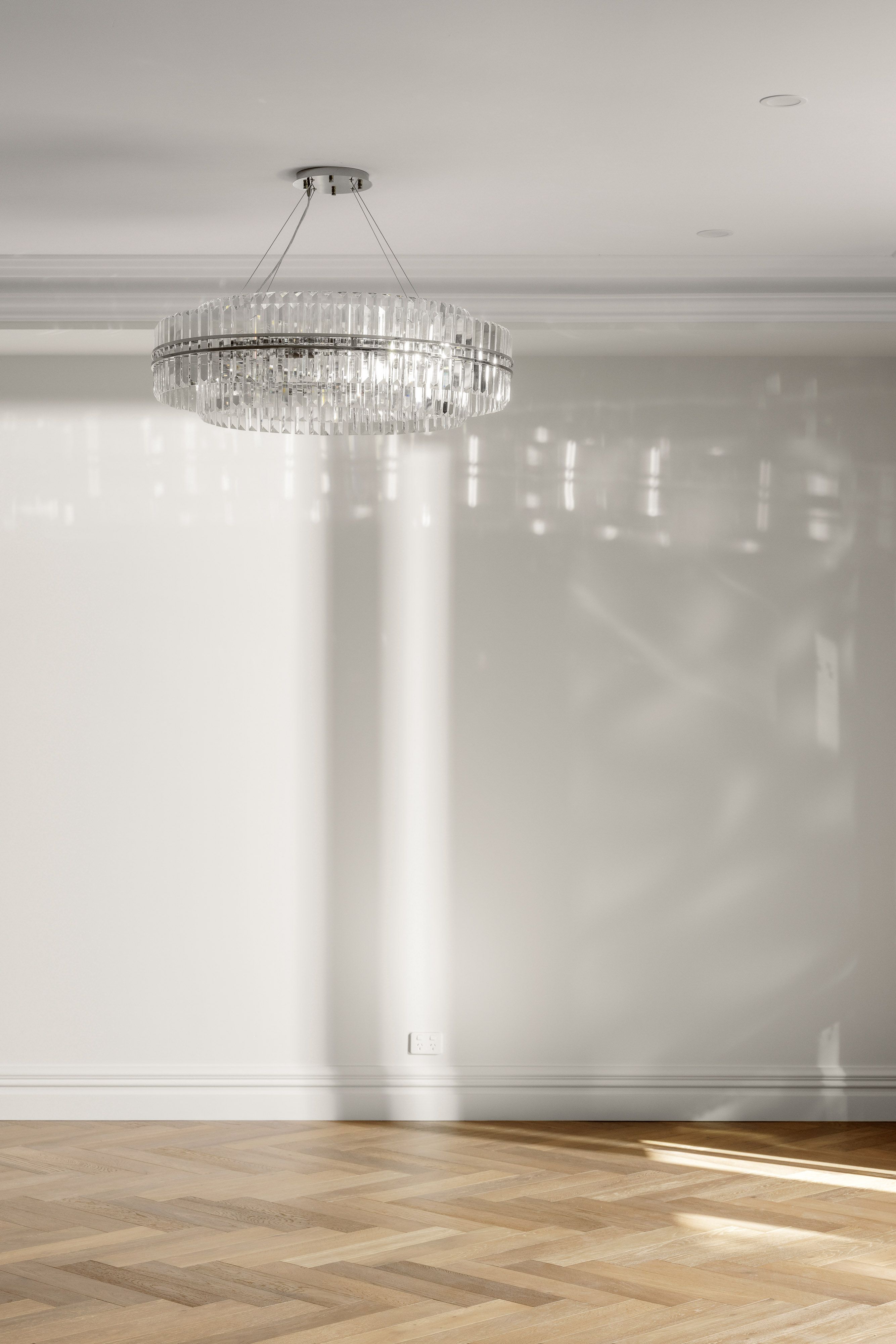 Smoked Brown herringbone floor detail beneath a chandelier in Balwyn.