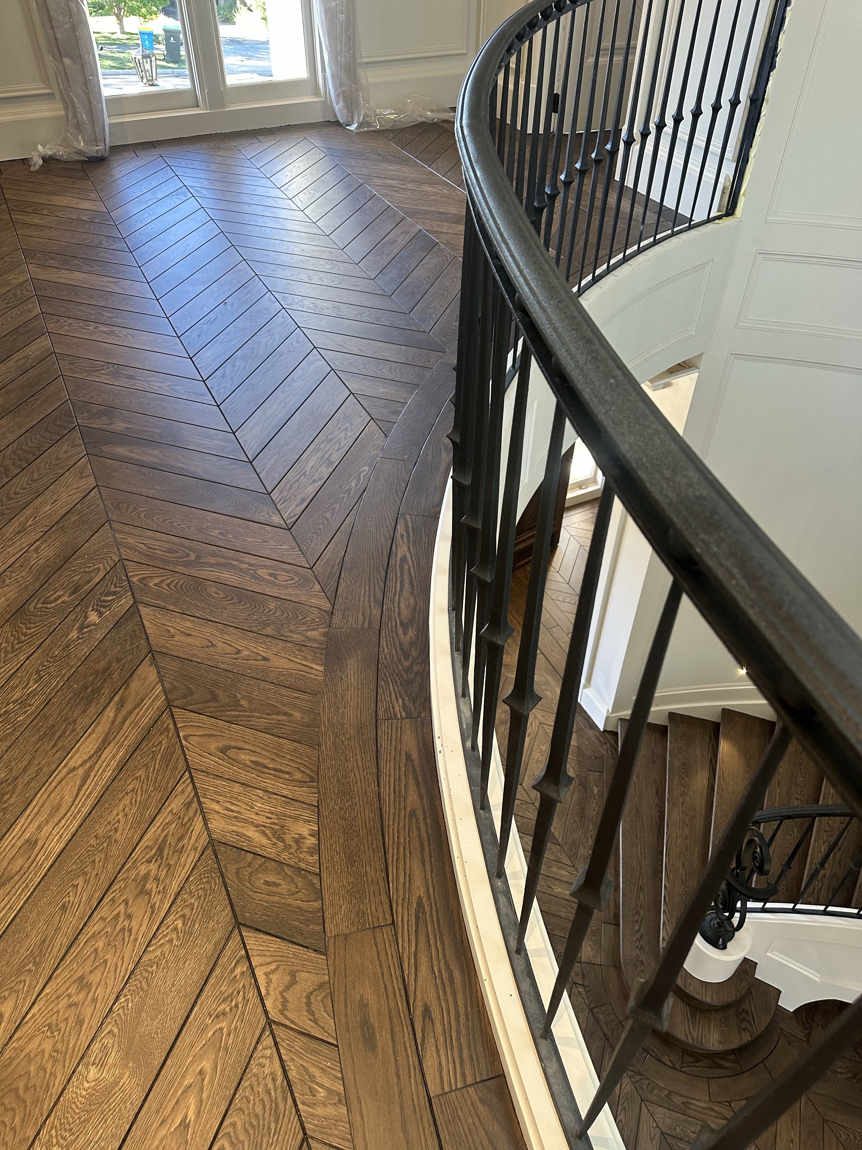 Chevron flooring fitted around the curved stair void in Balwyn North.