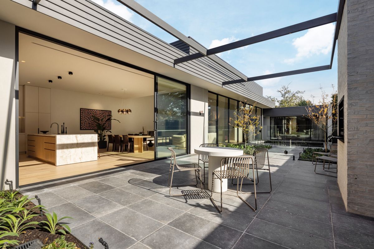 Kew courtyard framed by interiors with Avoca Bay engineered oak flooring.