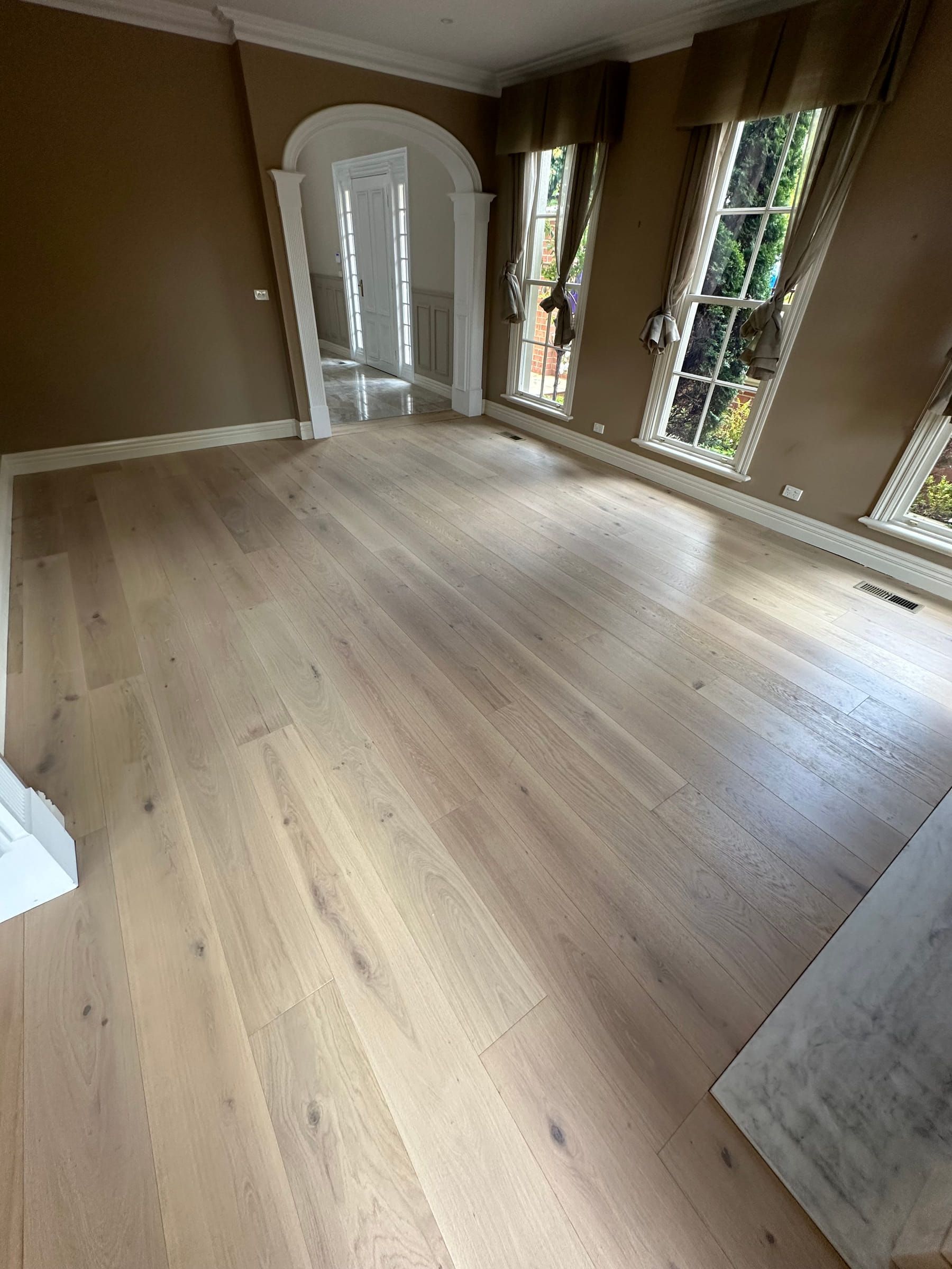 Light Tealight engineered oak flooring in a Camberwell room with tall windows.