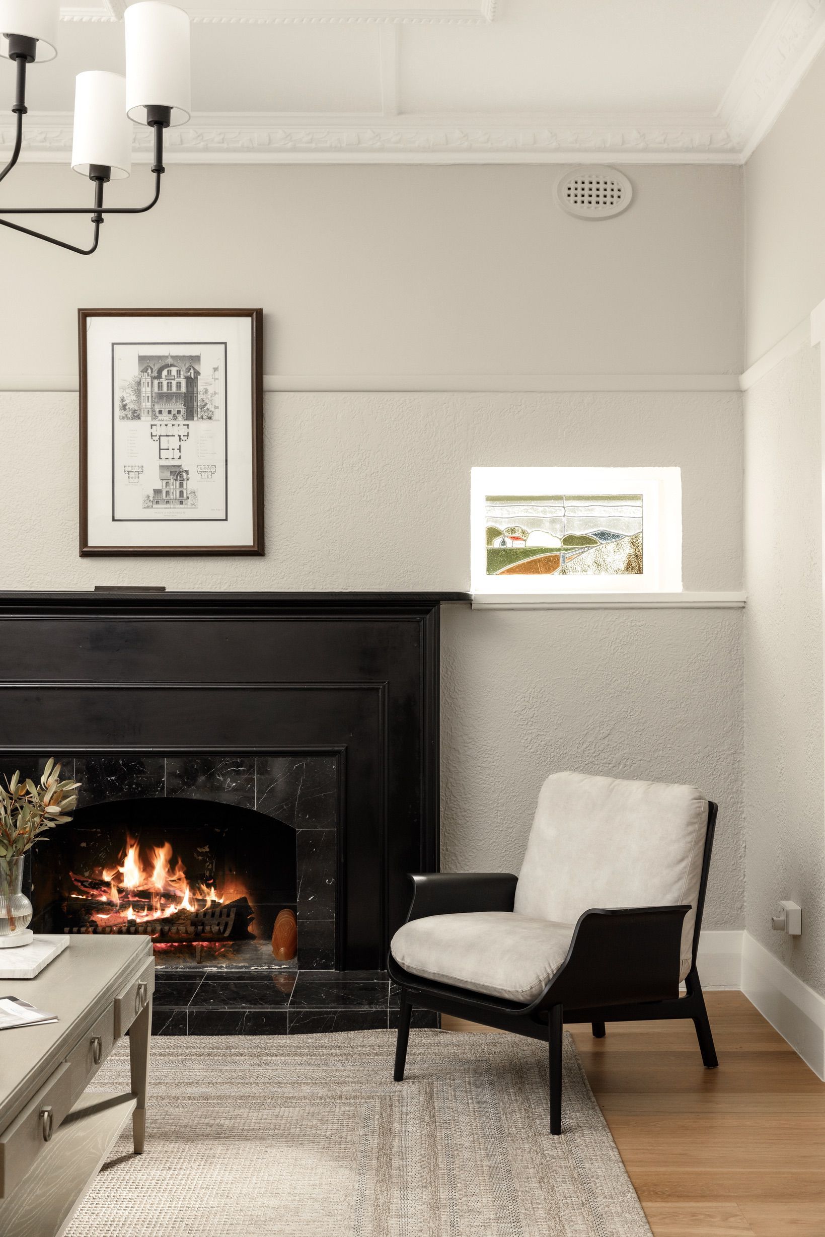 Chesterfield flooring in a Canterbury sitting room with a traditional fireplace.