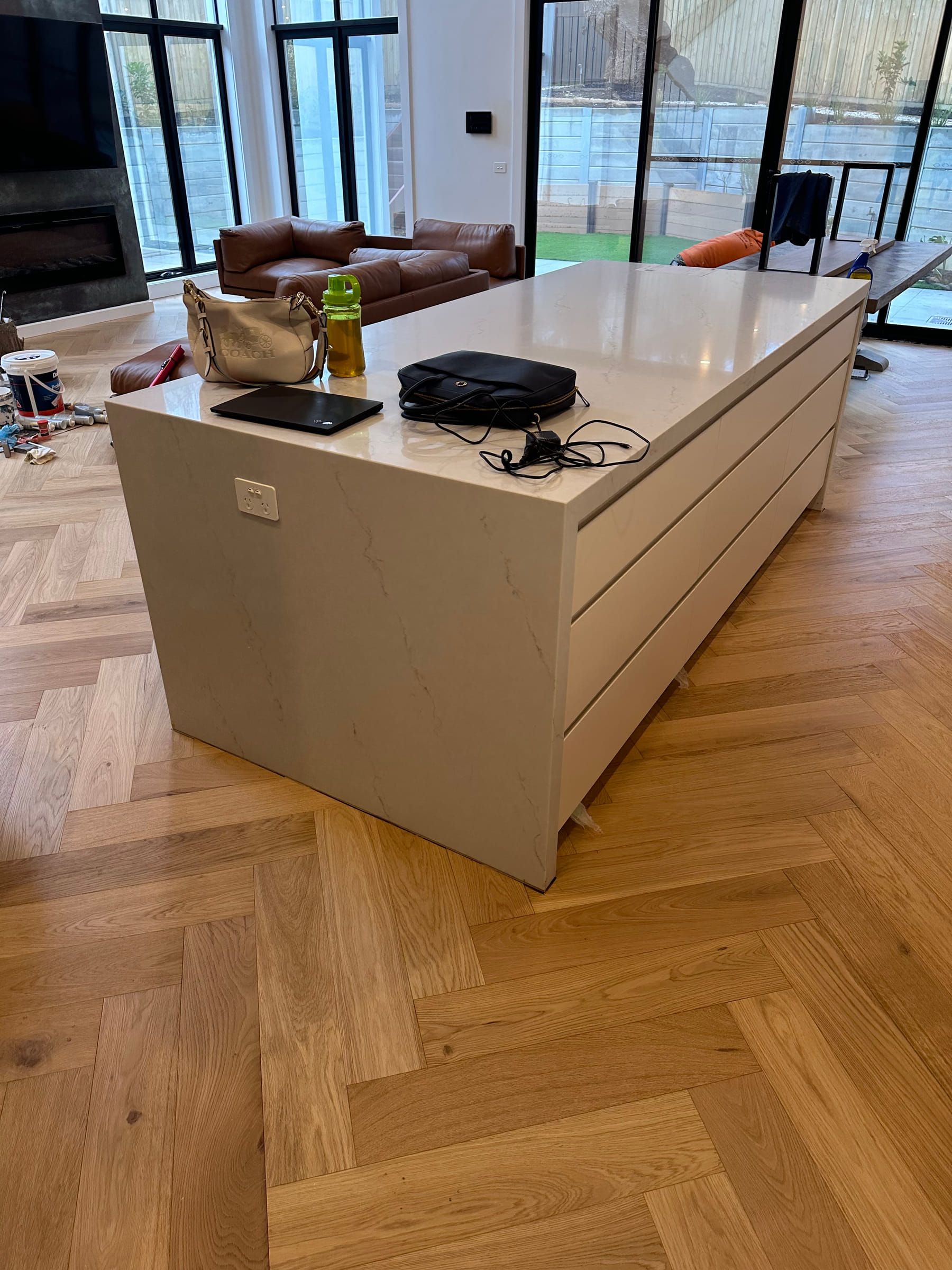 GrandOak herringbone flooring around a kitchen island in a Canterbury residence.