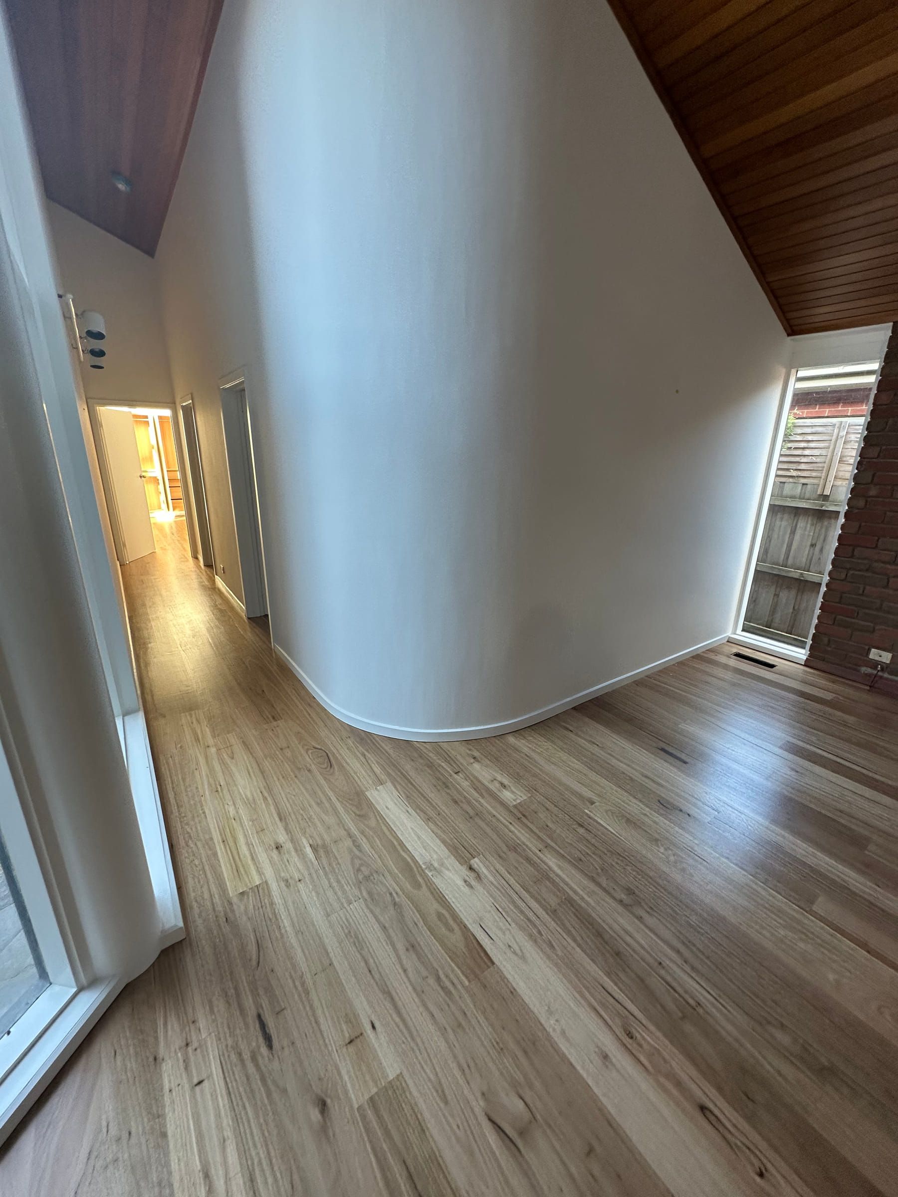 Solid Blackbutt flooring following a curved interior wall into a Malvern hallway.