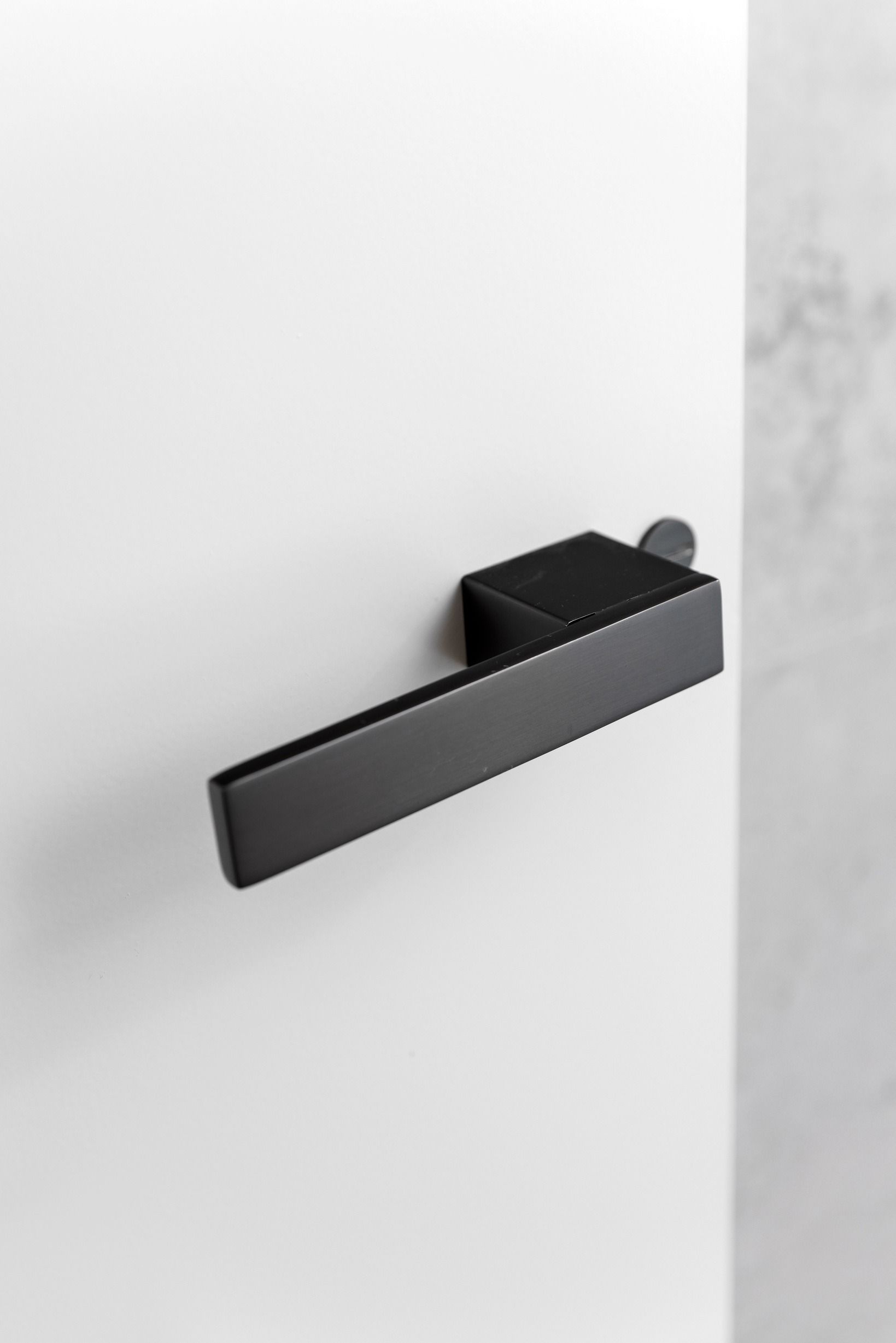 Minimal black wall light detail in the Glen Iris residence.