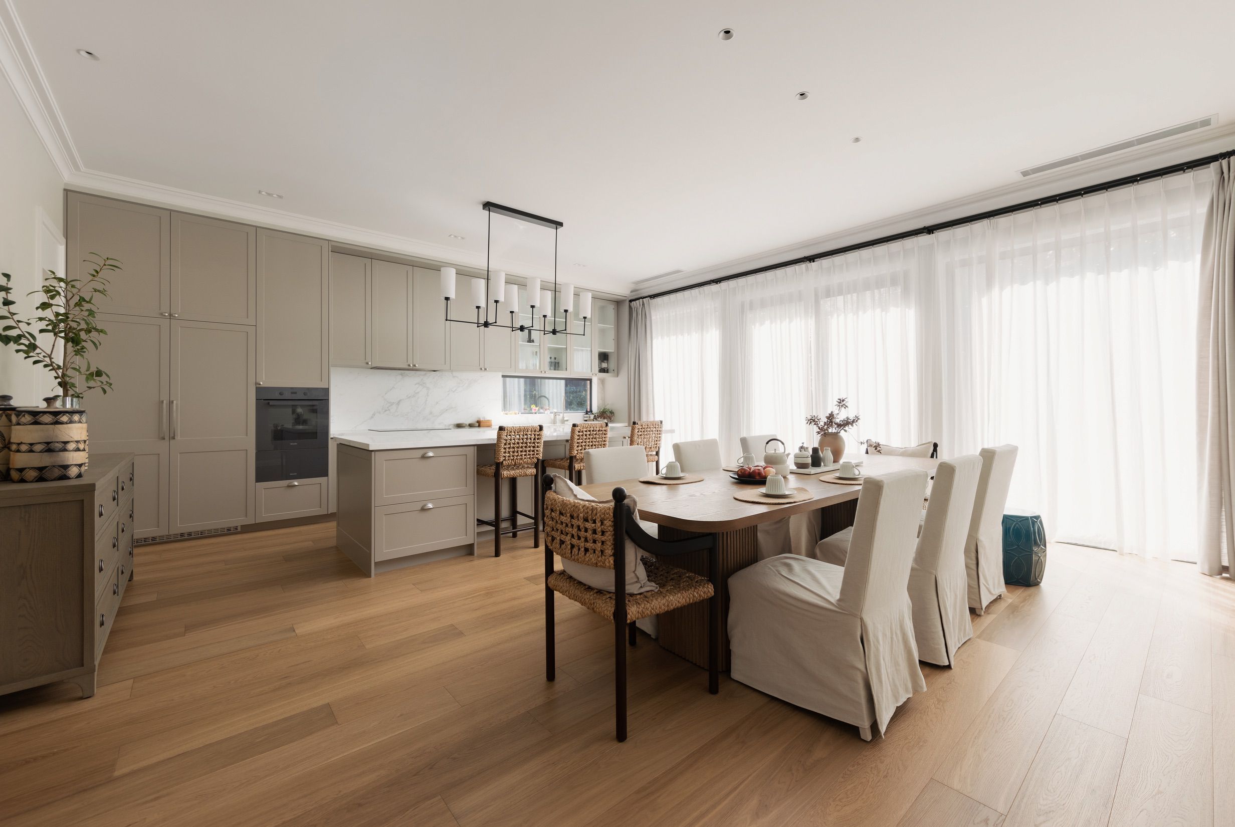 Chesterfield engineered oak flooring through an open-plan Canterbury kitchen and dining area.