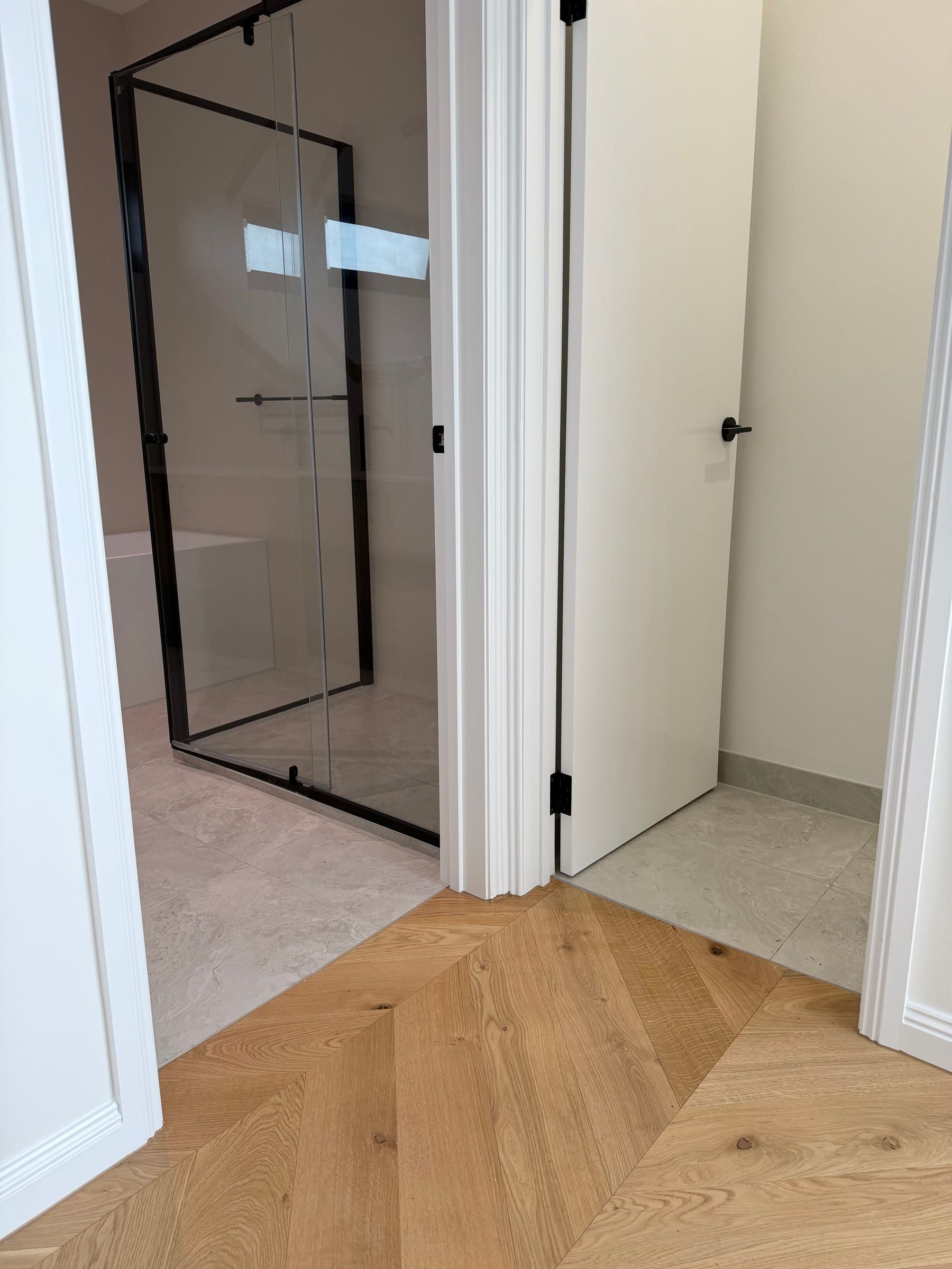 Natural Oak chevron flooring finished at tiled bathroom and utility-room thresholds in Bulleen.