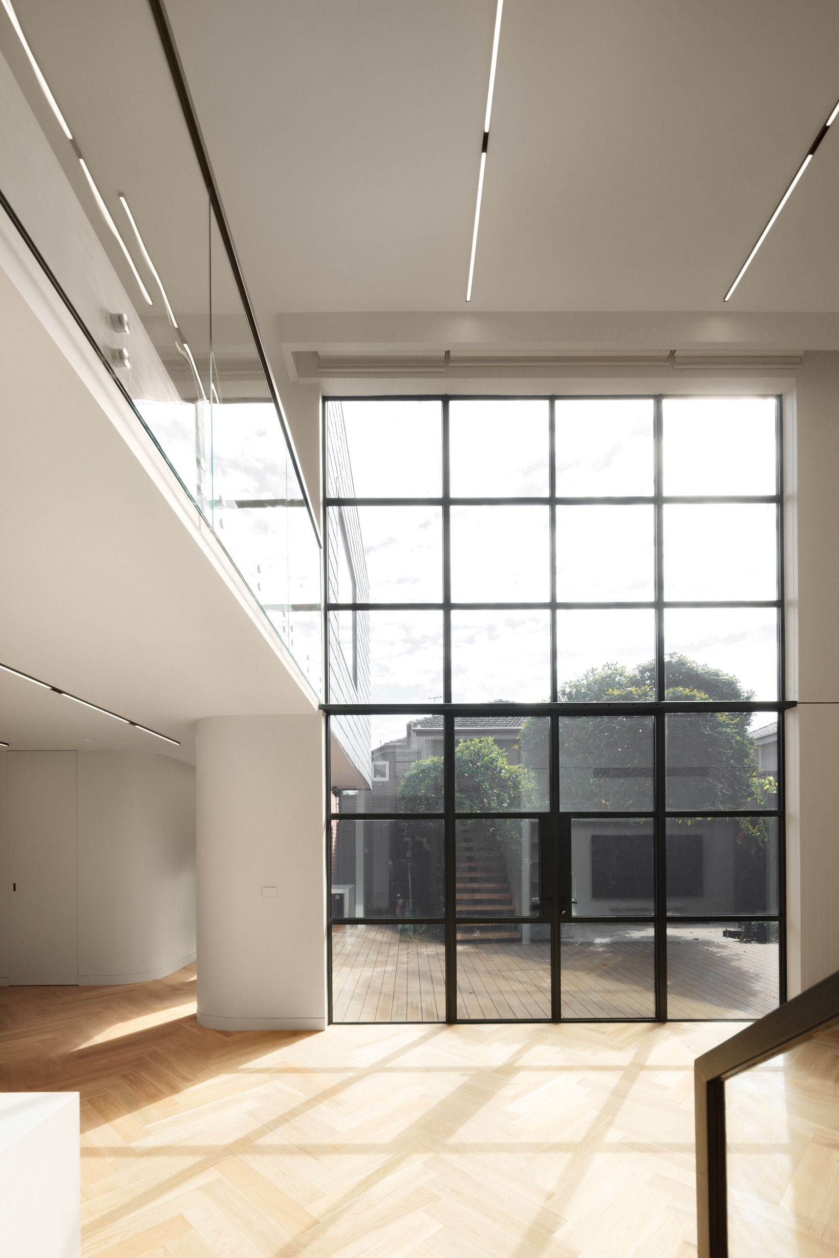 Natural Oak herringbone floor pattern beside full-height windows in Kew.