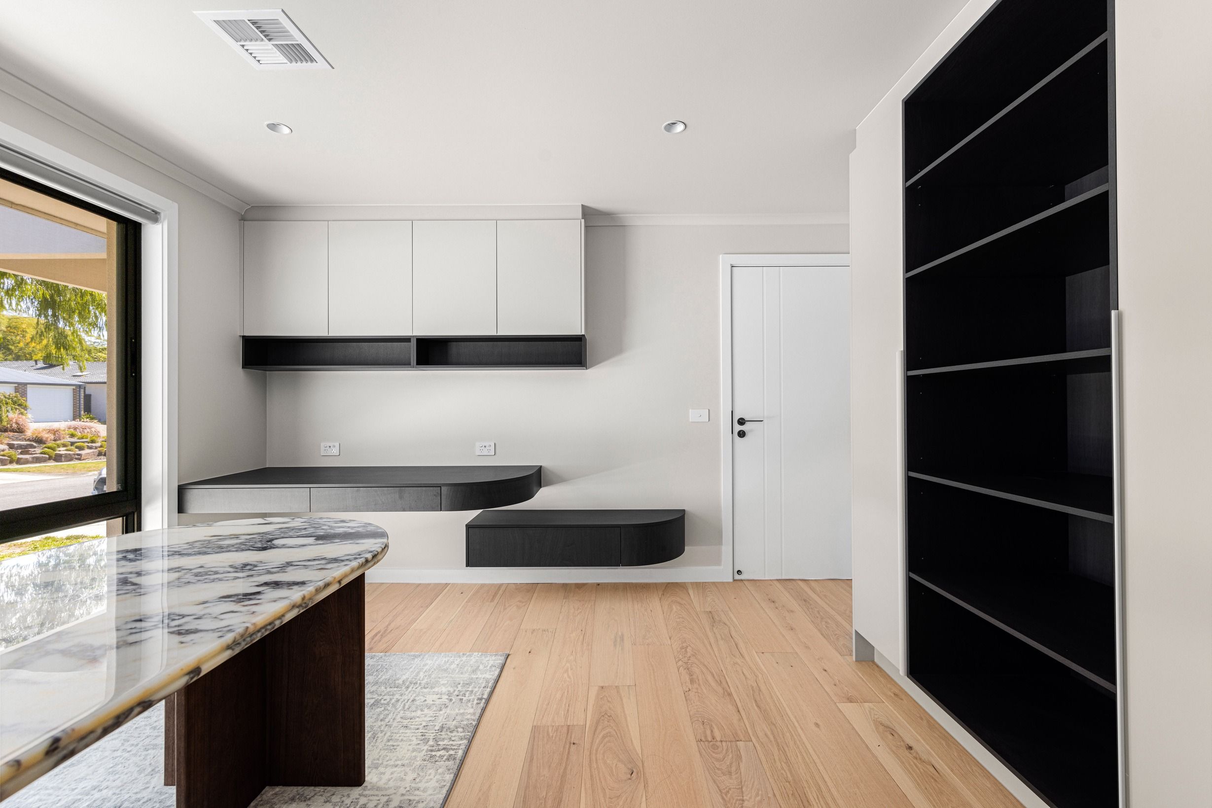 Danehill Hickory flooring below dark kitchen joinery in Wheelers Hill.