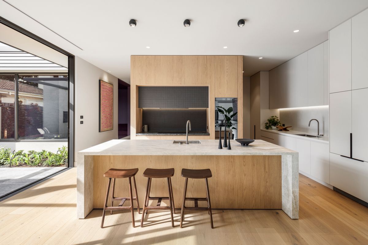 Avoca Bay oak flooring around a stone kitchen island in Kew.