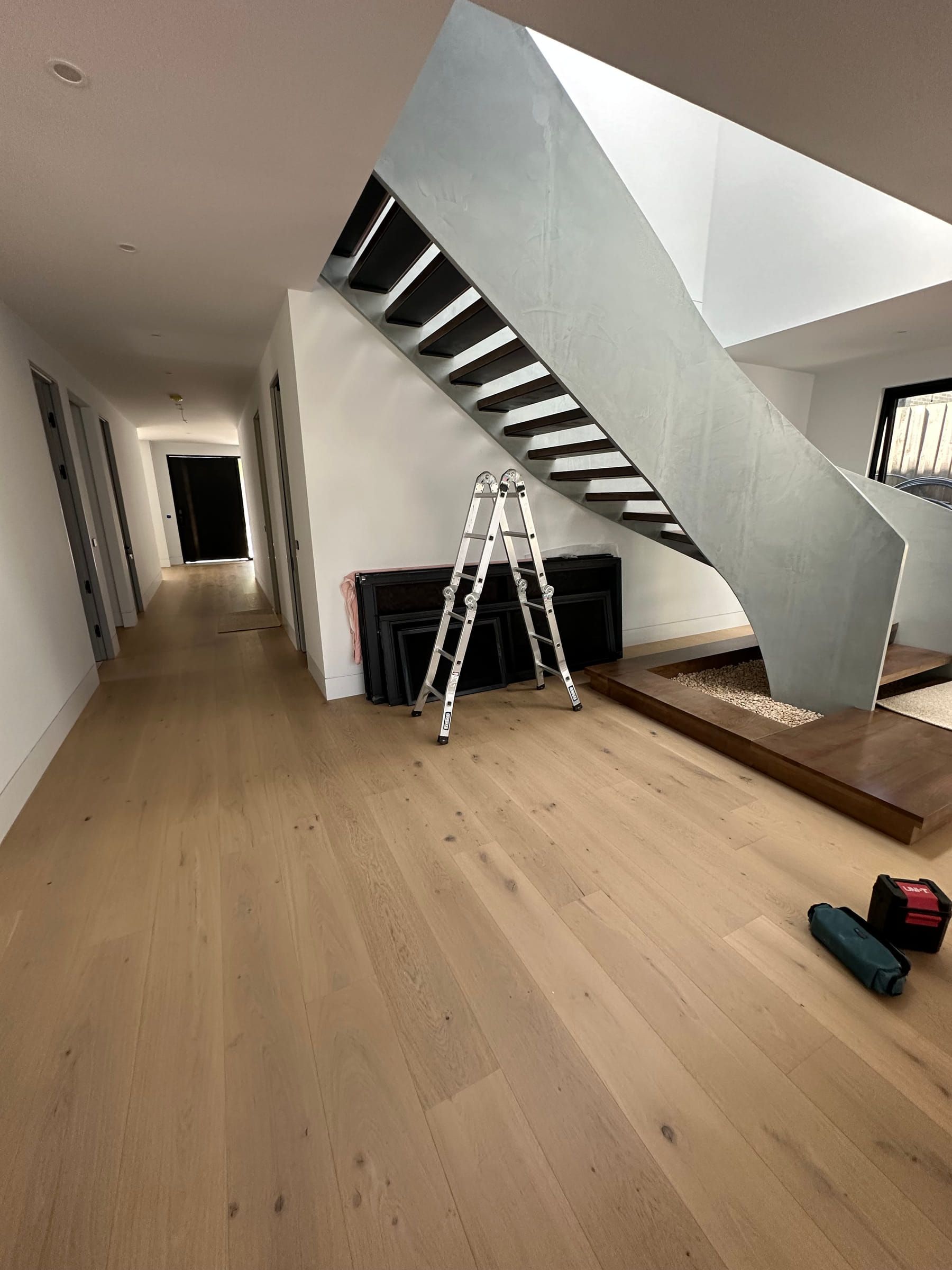 Light-toned Avoca Bay flooring beneath the staircase in a Camberwell residence.
