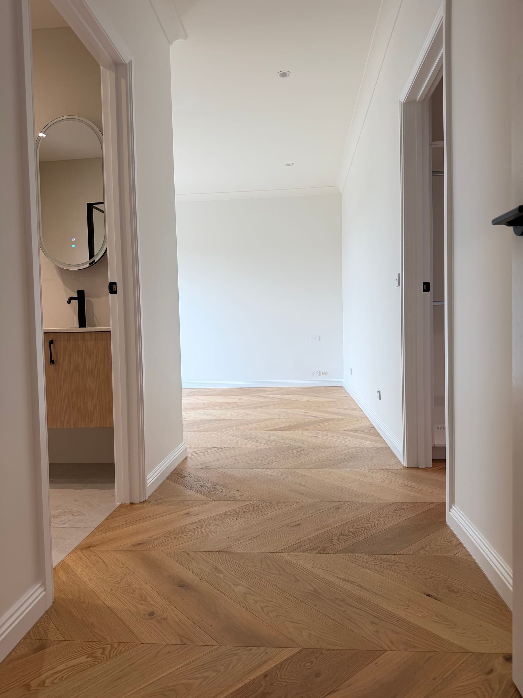 Chevron flooring continuing from a hallway into an open residential room in Bulleen.