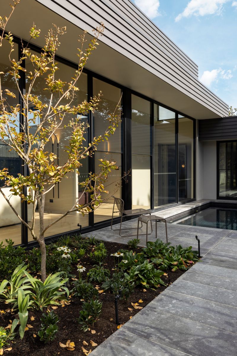Landscaped Kew courtyard adjoining rooms finished with Avoca Bay oak flooring.
