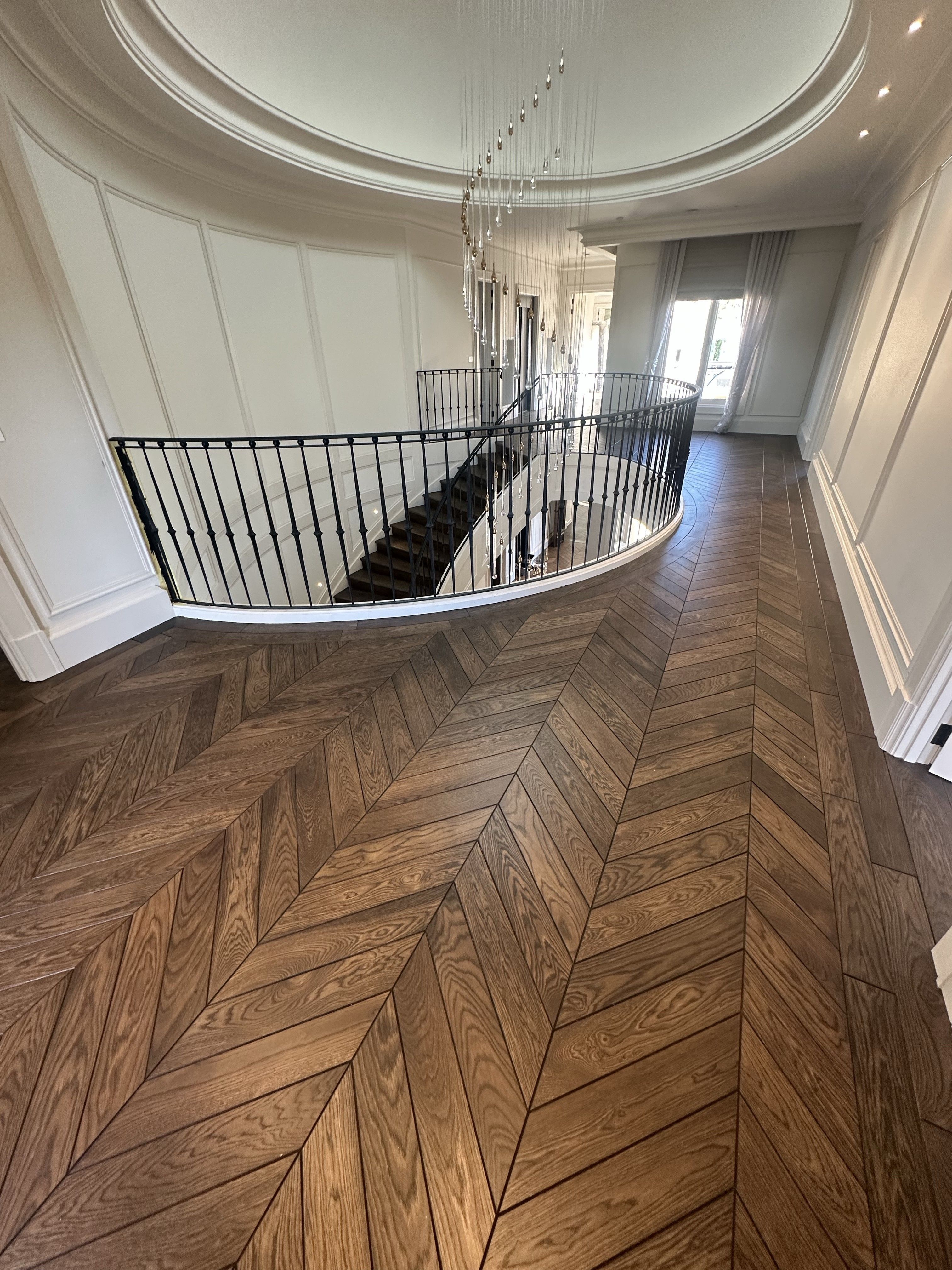 Solid oak chevron flooring across a curved Balwyn North landing.