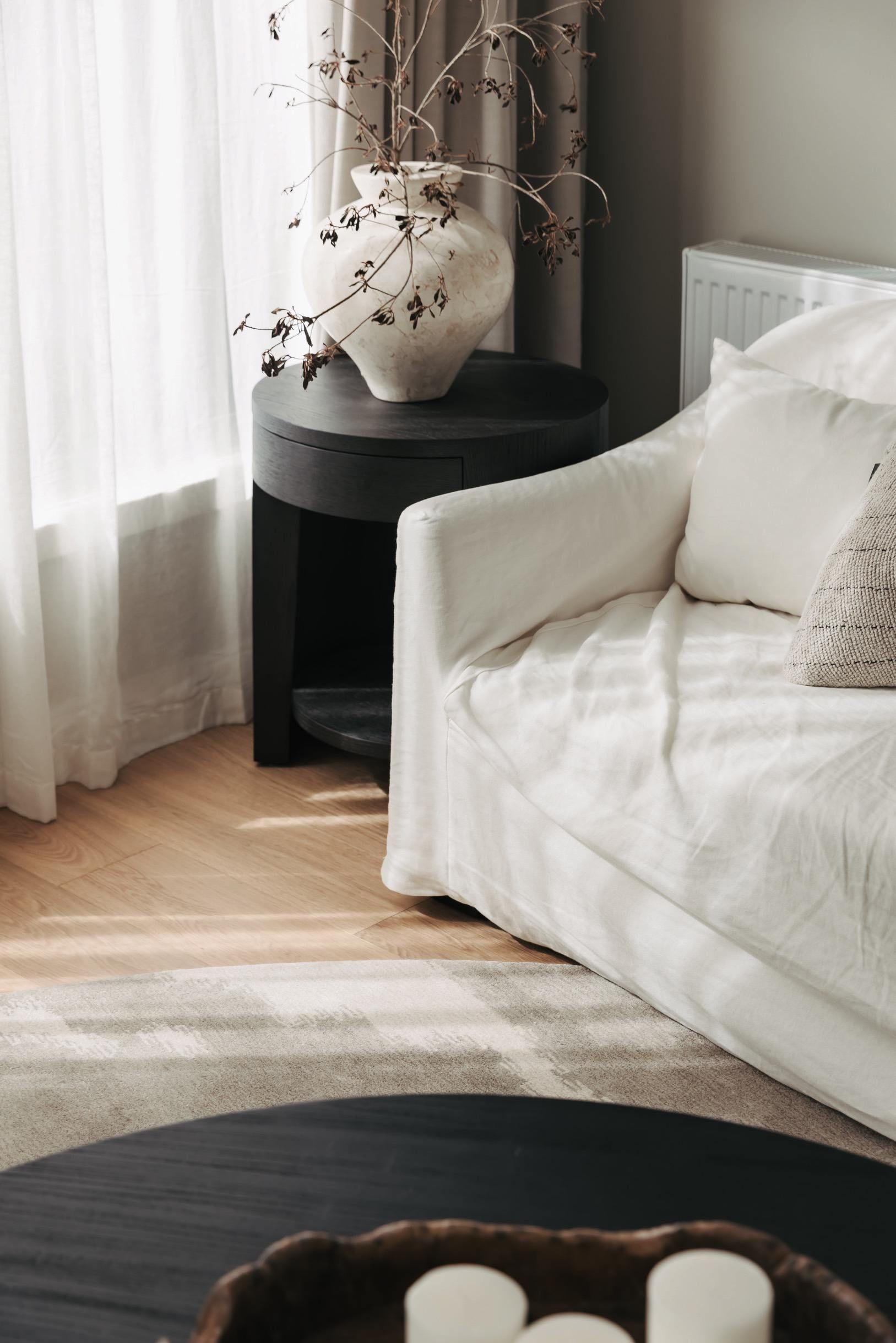 Chesterfield oak flooring beside a sofa and window in a Canterbury living area.