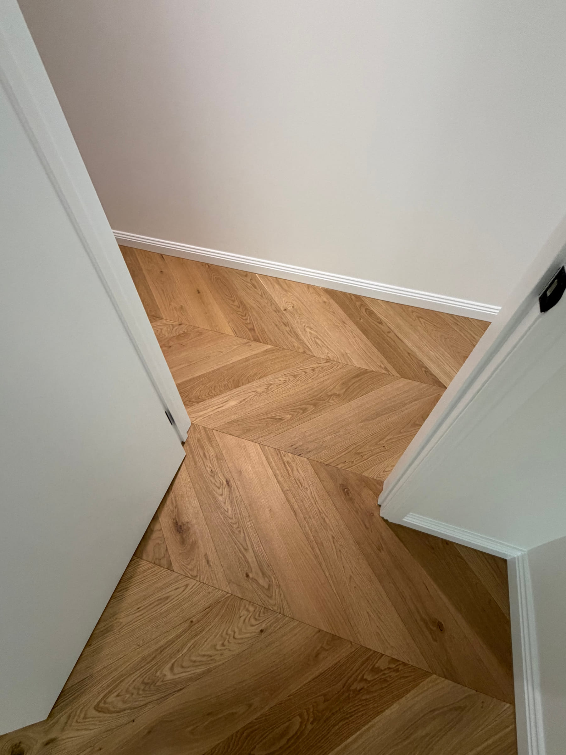 Chevron floor set-out continuing through a narrow doorway in the Bulleen residence.