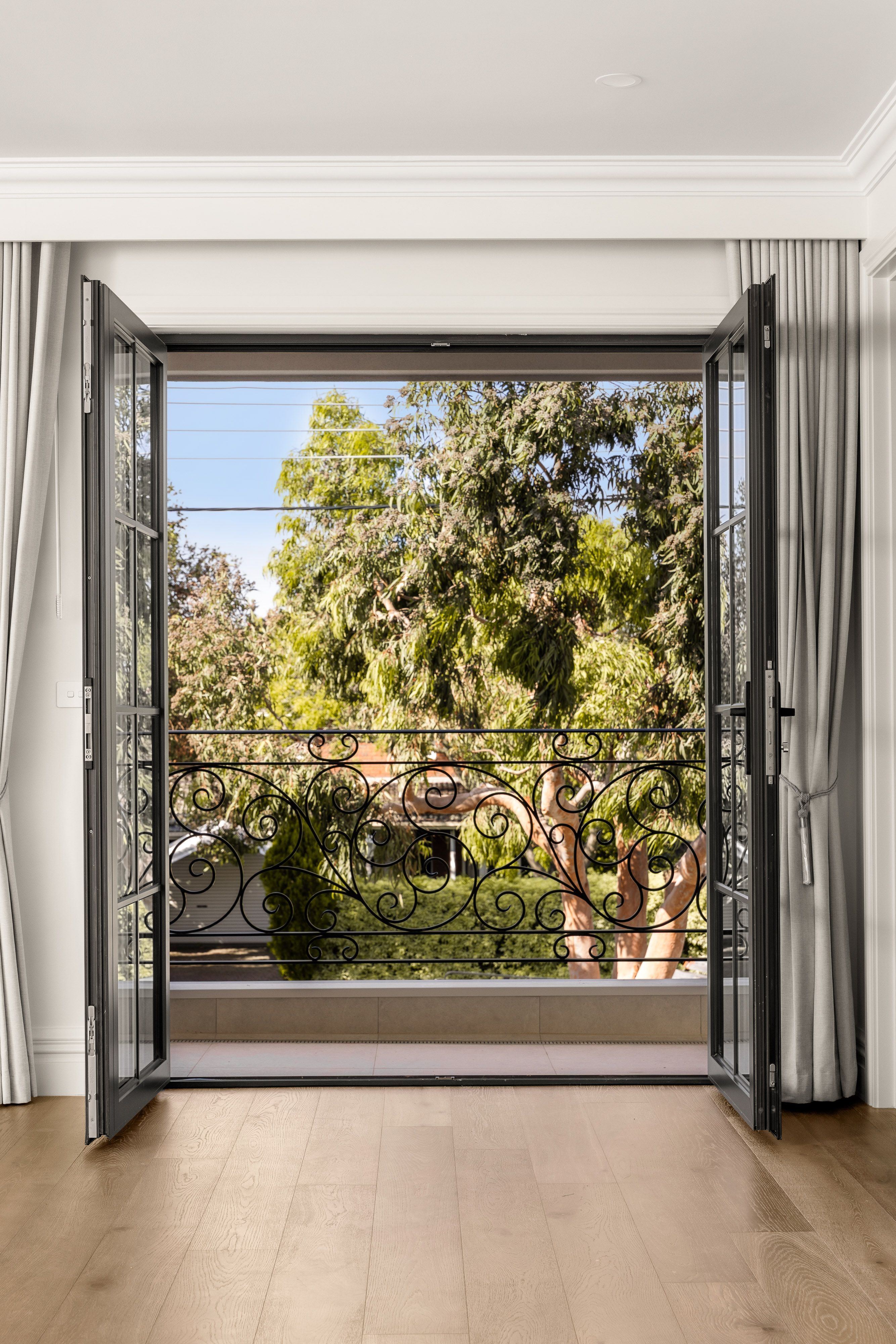 Smoked Brown oak flooring beside black-framed balcony doors in Balwyn.