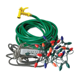 Coiled green garden hose with yellow nozzle, tangled colorful Christmas lights, a white power strip, and braided extension cords.