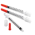 Three clear insulin syringes, two capped and one uncapped with its needle exposed.