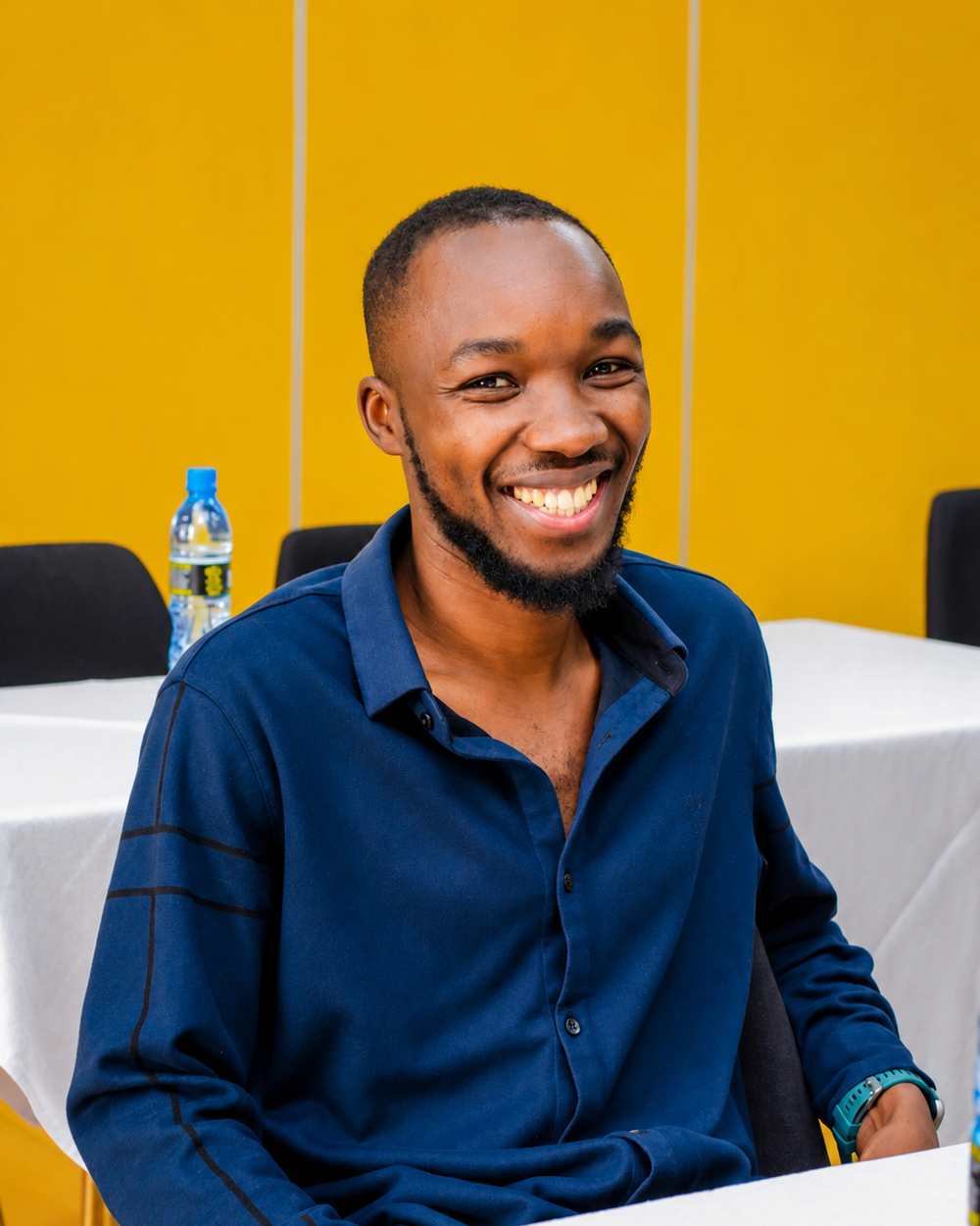 Smiling attendee in a blue shirt at a business event