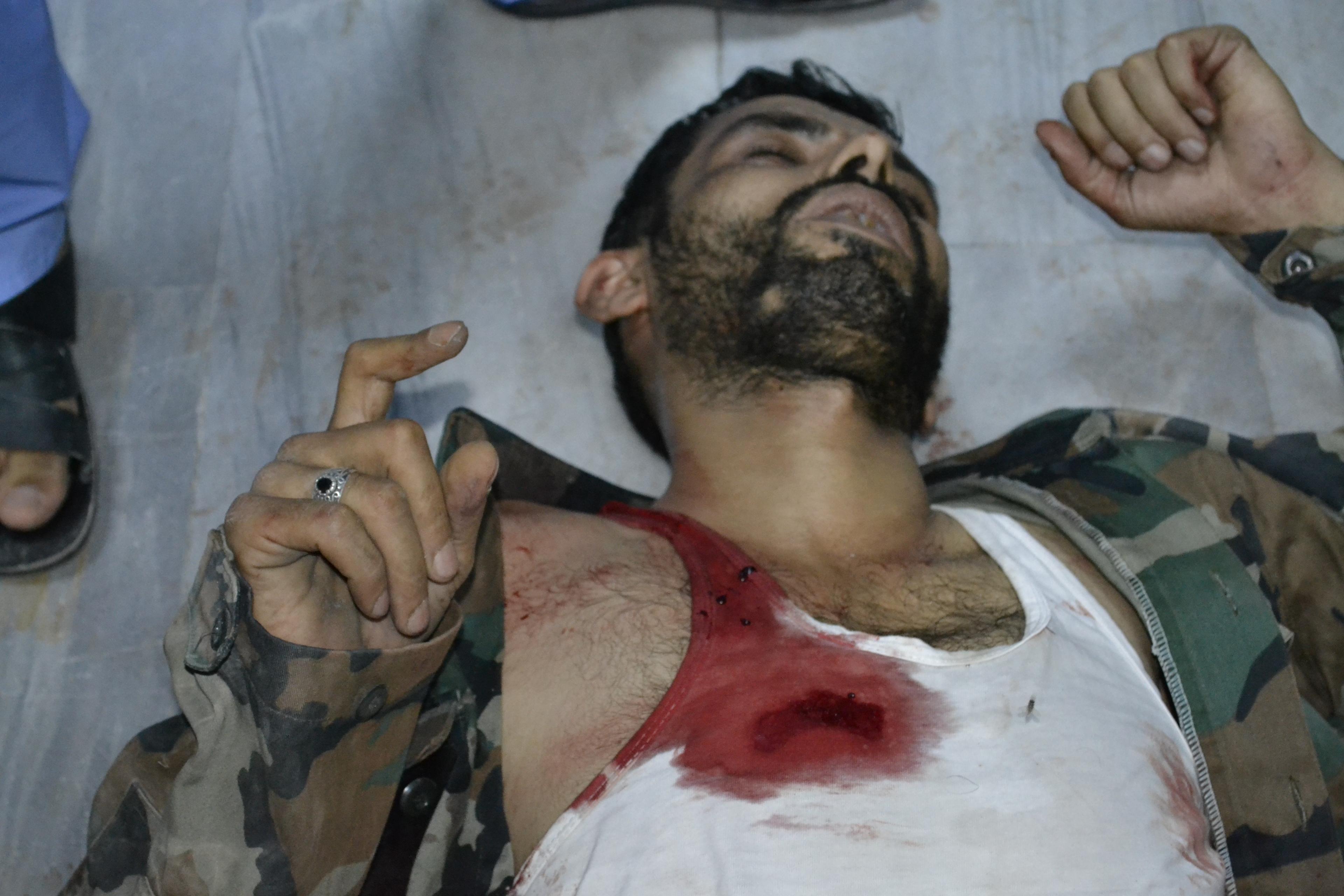 A free Syrian army fighter saying the "shahada" after being attacked on the frontline.