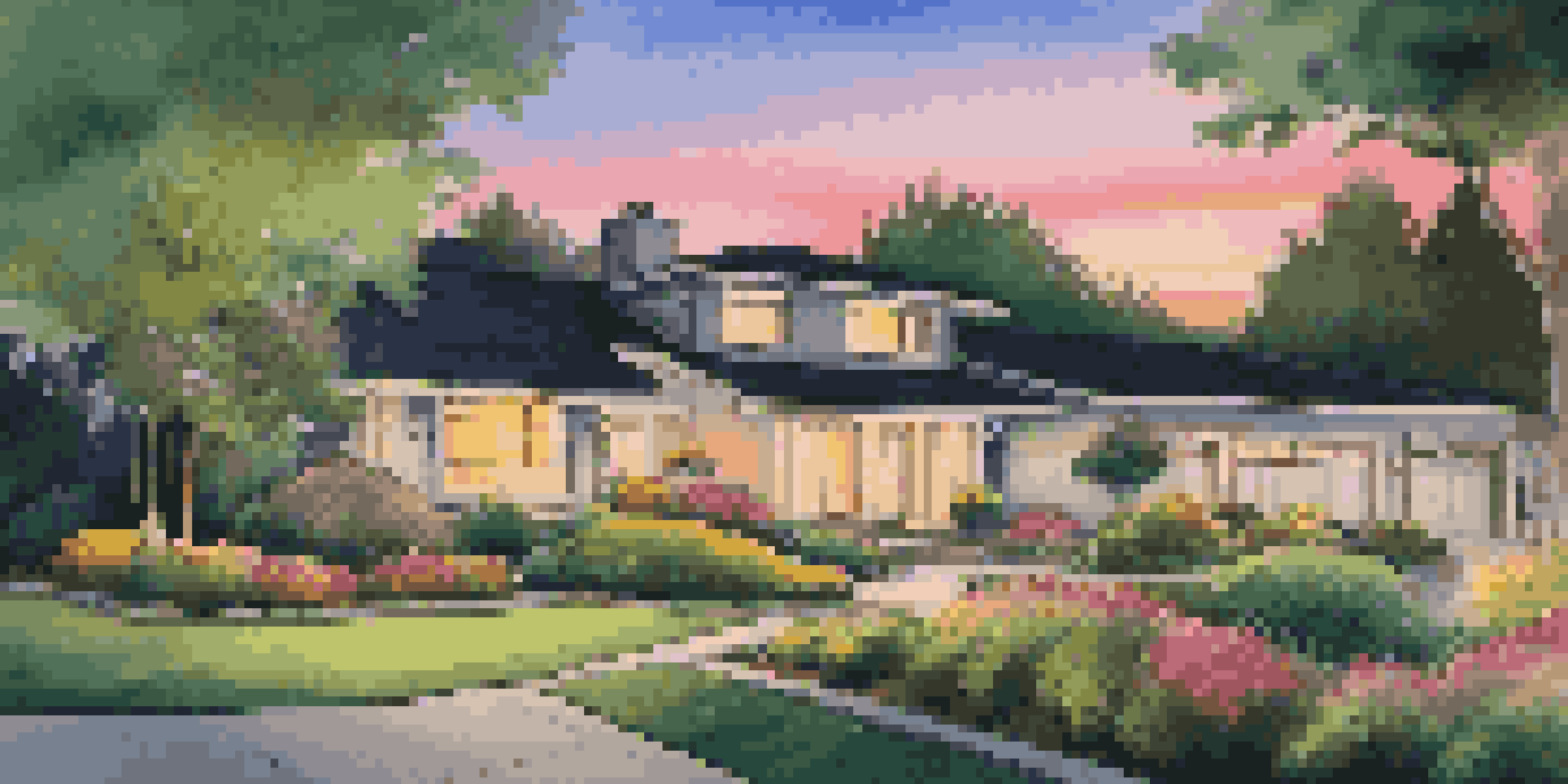 A modern home with a well-maintained front yard, illuminated by LED lights, and colorful flowers, creating a warm atmosphere at dusk.