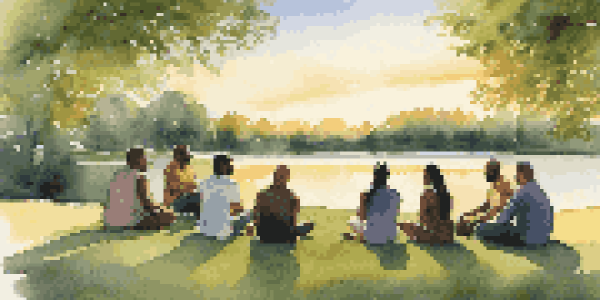 A diverse group of people sitting in a circle on a green lawn during sunset, engaged in mediation.