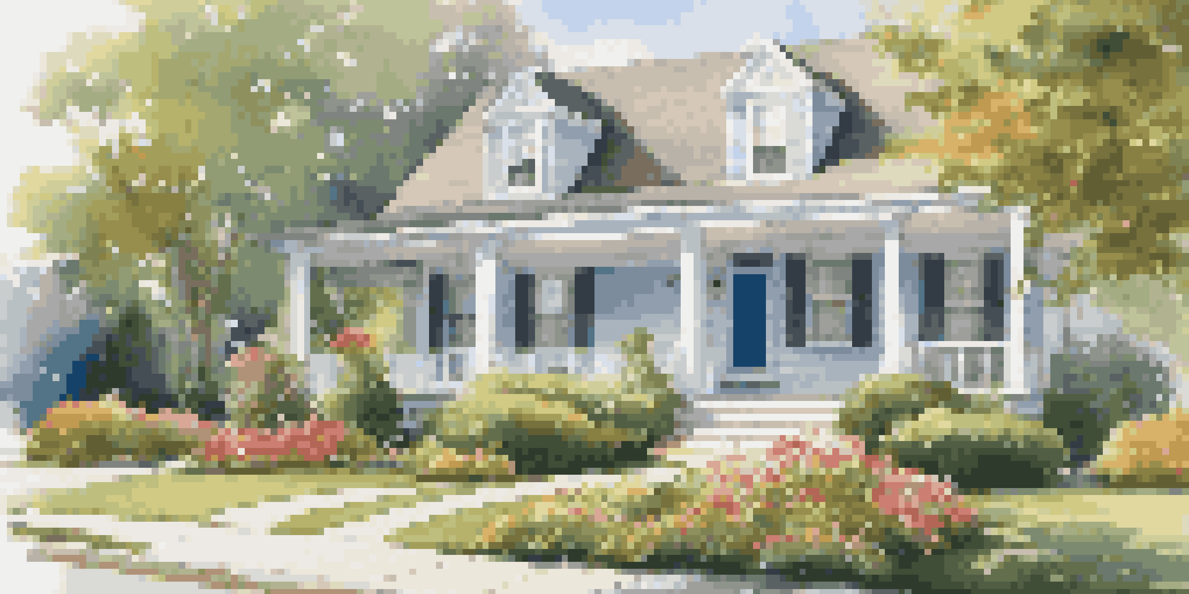 A beautifully maintained rental property with manicured landscaping and a cozy front porch.
