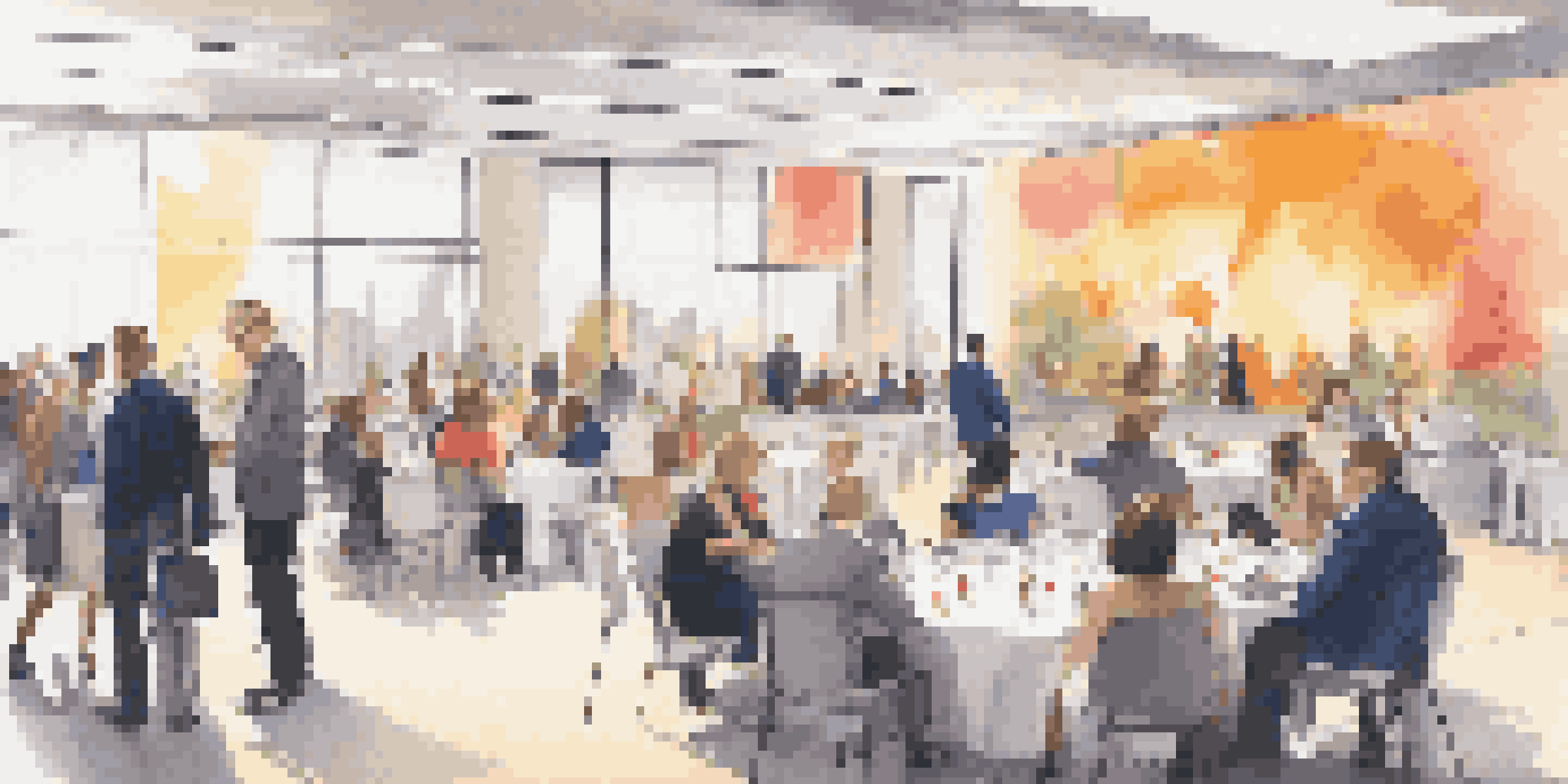 A lively networking event in a conference hall with diverse professionals discussing real estate syndication.