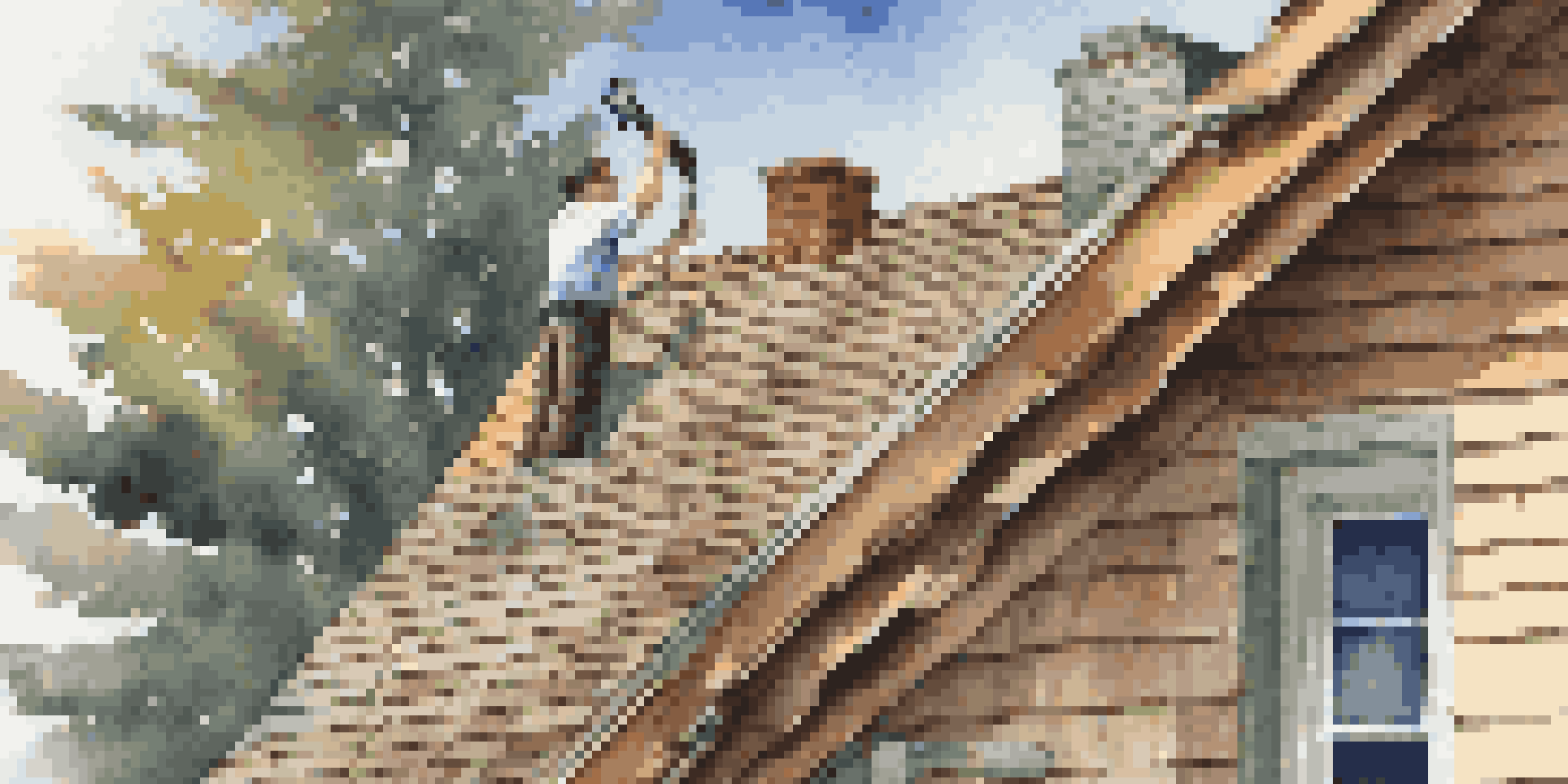 A home inspector inspecting the roof of a house with a flashlight, highlighting shingles and beams under warm lighting.