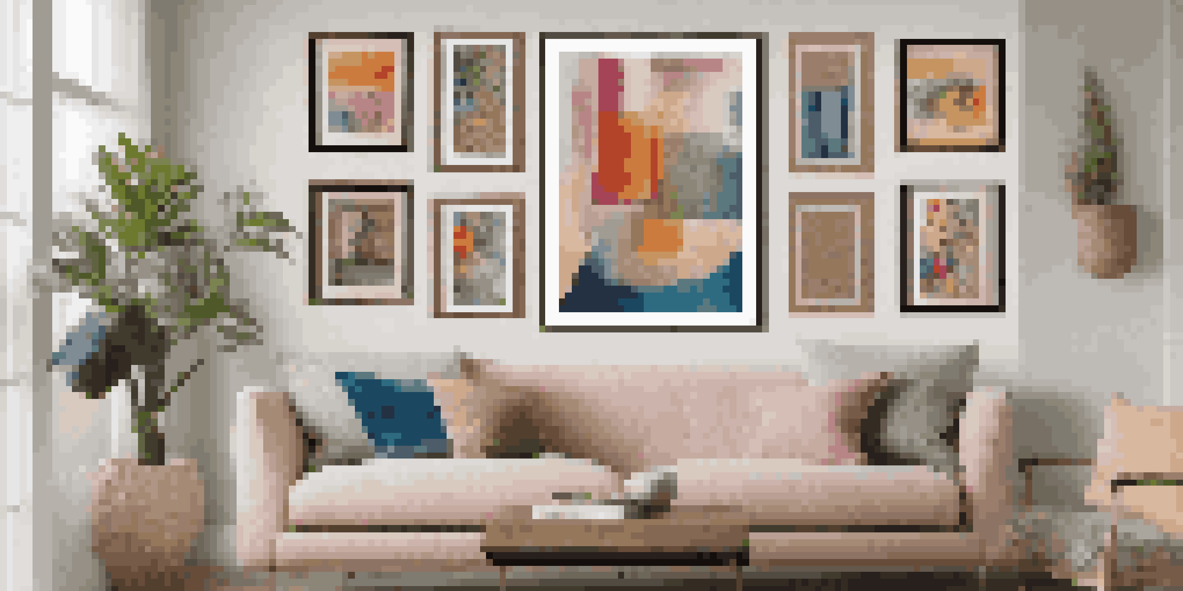 An eclectic wall art display showcasing a variety of colorful abstract paintings and vintage photographs, arranged in a visually balanced manner against a neutral background.