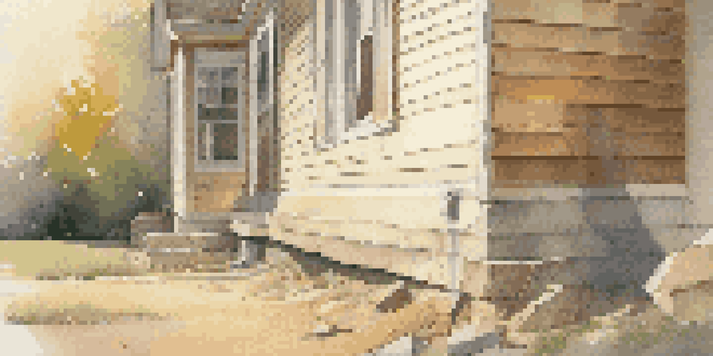A home inspector closely examining a house's foundation, using a flashlight to check for cracks during sunset.