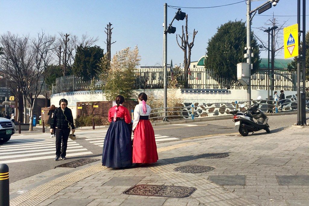 Visitors wearing hanbok near Bukchon Hanok Village in Seoul's historic old town.
