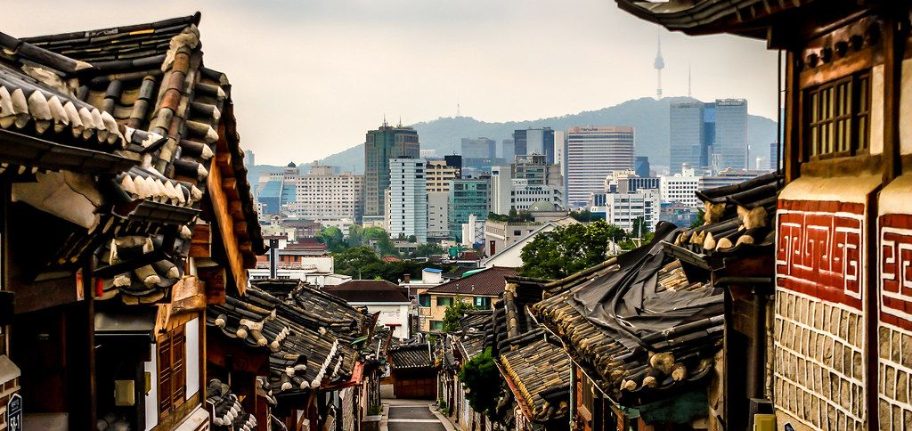 Bukchon Hanok Village in Seoul, with traditional Korean tiled-roof houses.