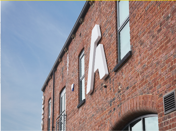 Photo of brick building with large white A letter