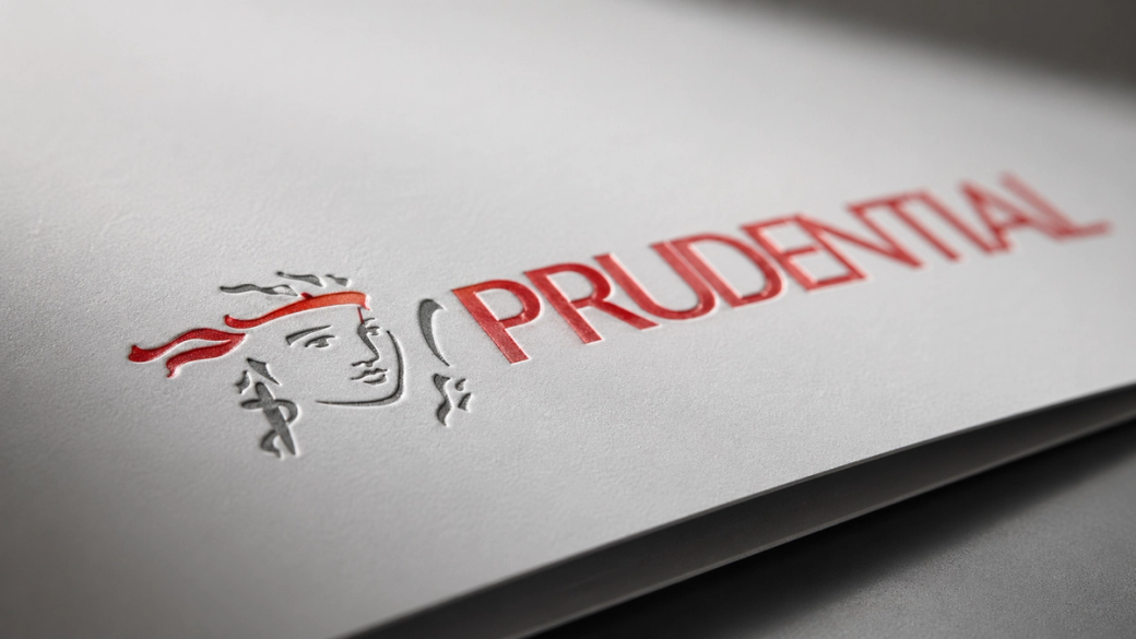 The image features the logo of Prudential, prominently displayed against a textured gray background. The logo includes a stylized figure of a person with a headband, conveying a sense of strength and assurance.