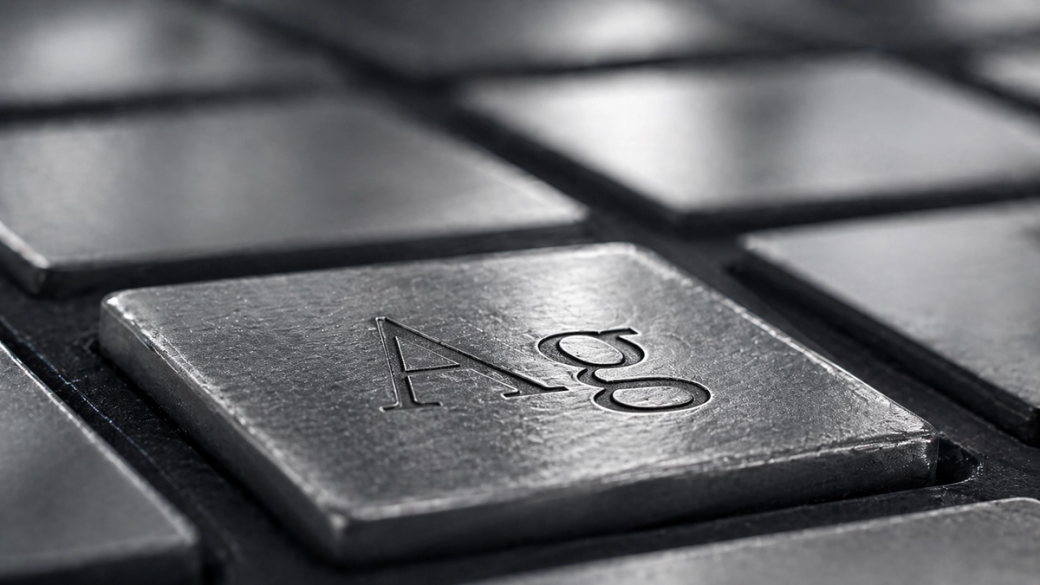 A close-up view of a metallic keyboard key featuring the chemical symbol 'Ag', which represents silver in the periodic table. The image highlights the texture and shine of the key, emphasizing its metallic finish.