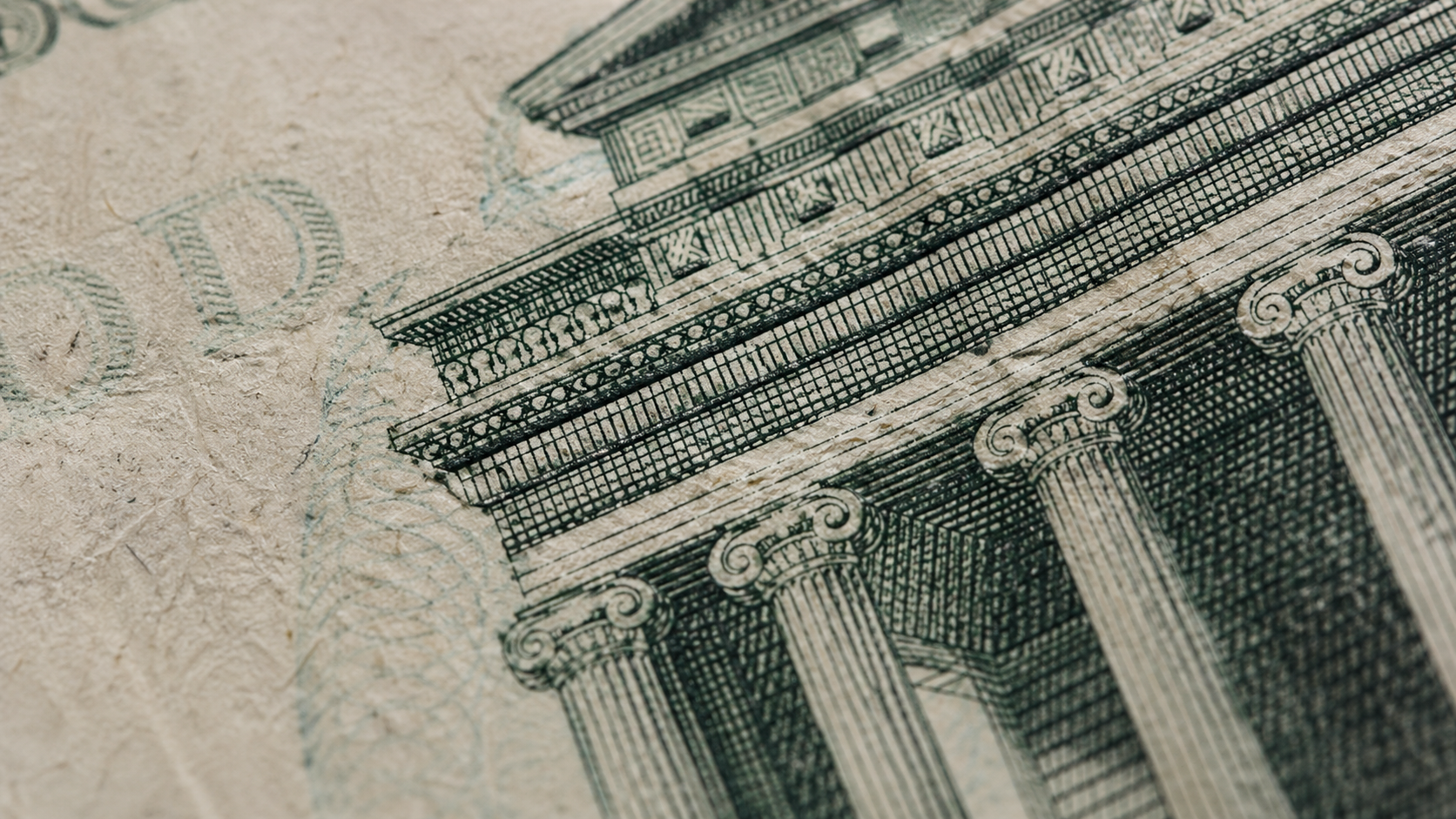 The image features a close-up view of architectural details from a banknote, showcasing intricate designs of columns and a façade. It highlights the craftsmanship involved in currency design.