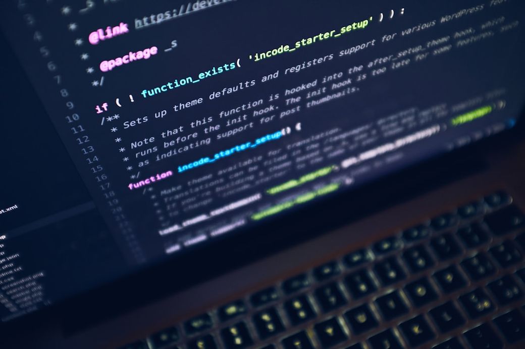 The image captures a close-up view of computer code displayed on a screen. The code appears to be related to theme setup in a programming context, showcasing various functions and comments. — Credit: Photo by Luca Bravo on Unsplash