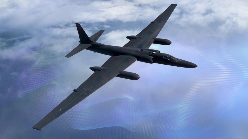 An advanced reconnaissance aircraft, the U-2, is captured soaring through a cloudy sky. Its sleek black body reflects its design for high-altitude intelligence gathering missions.
