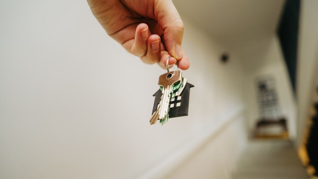 Hand holding door keys new house real estate stairs — Credit: Photo by Jakub Żerdzicki on Unsplash